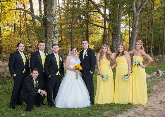 Wedding party in white, yellow and black attire.