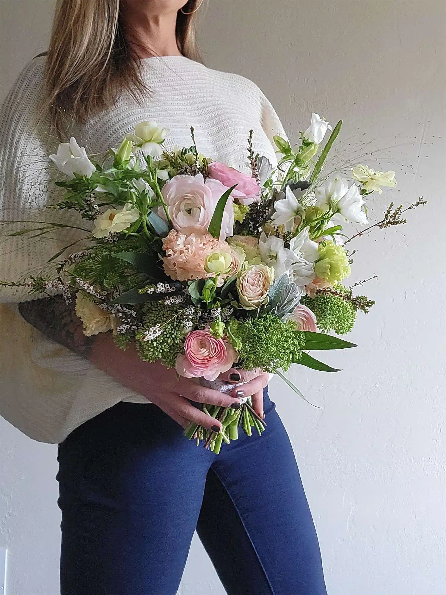 Woman holding bridal bouquet.