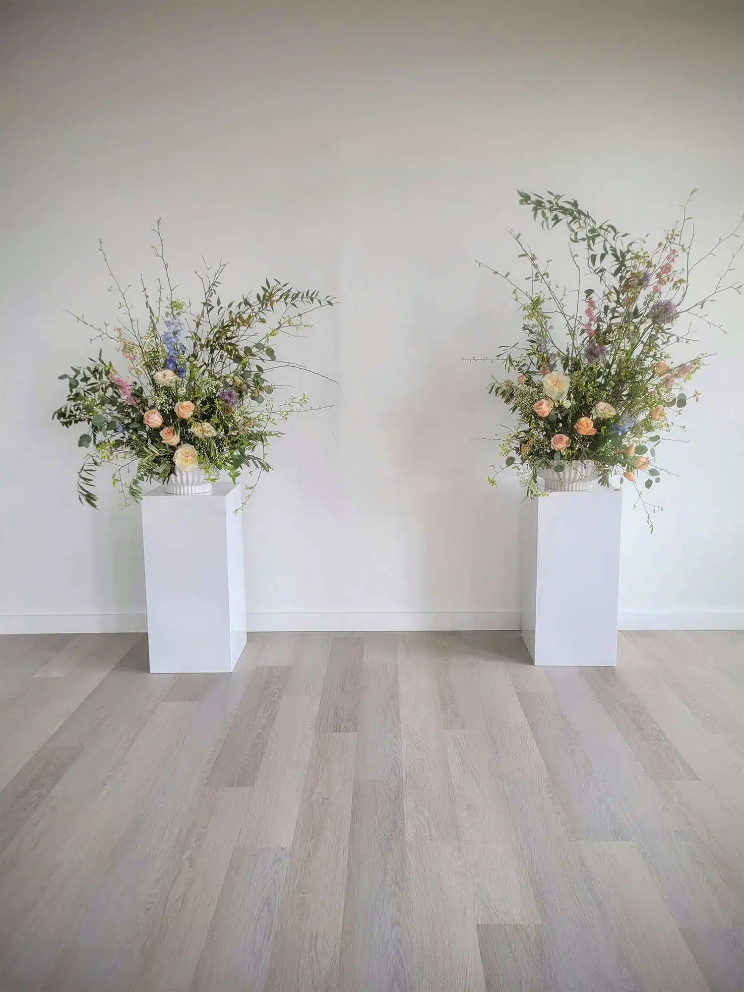 A pair of pillar floral installations created by Archer & Bliss Floral of Shawano, WI.