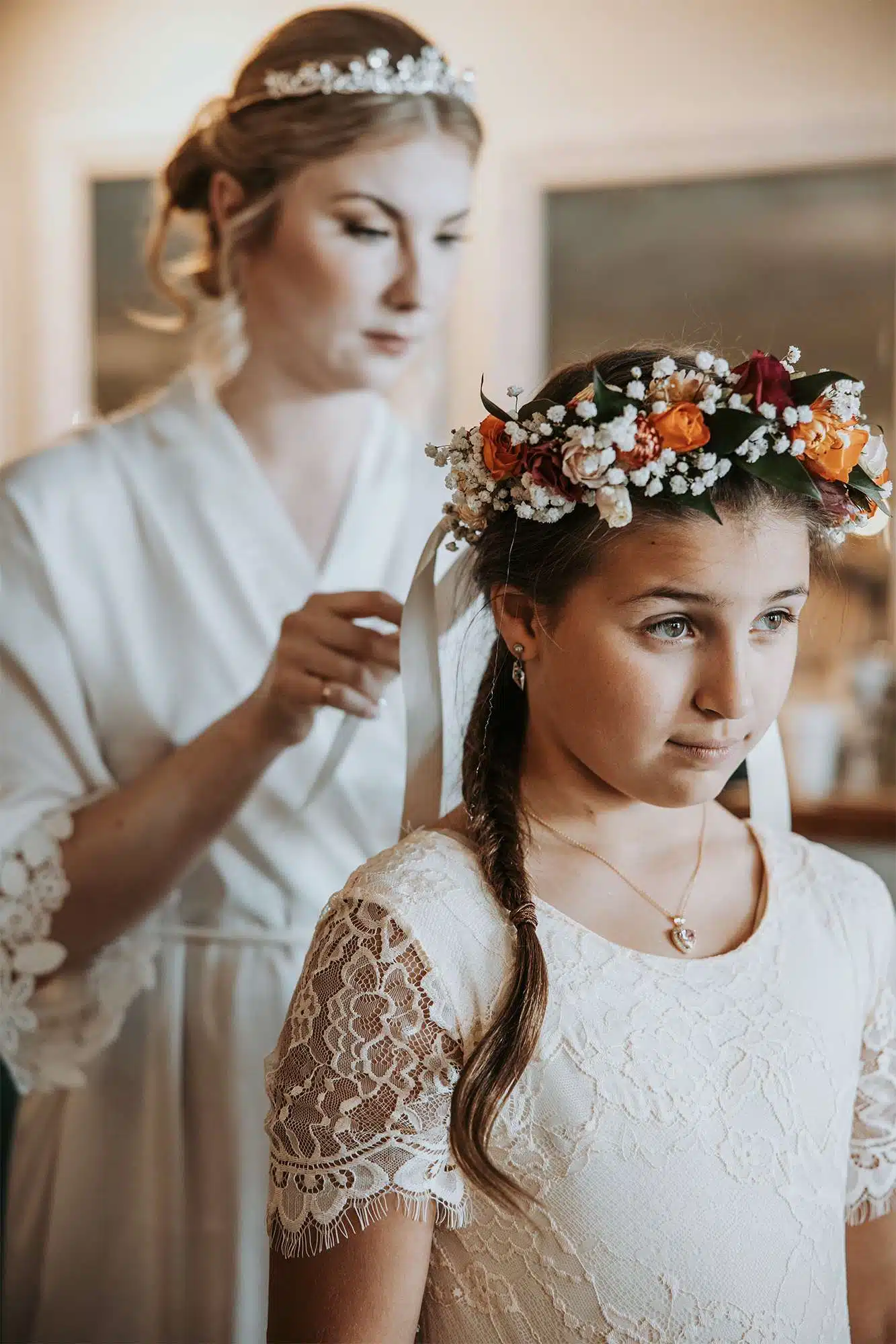 Flower girl getting ready with floral crown and ribbon detail by Archer & Bliss Floral during wedding preparations.