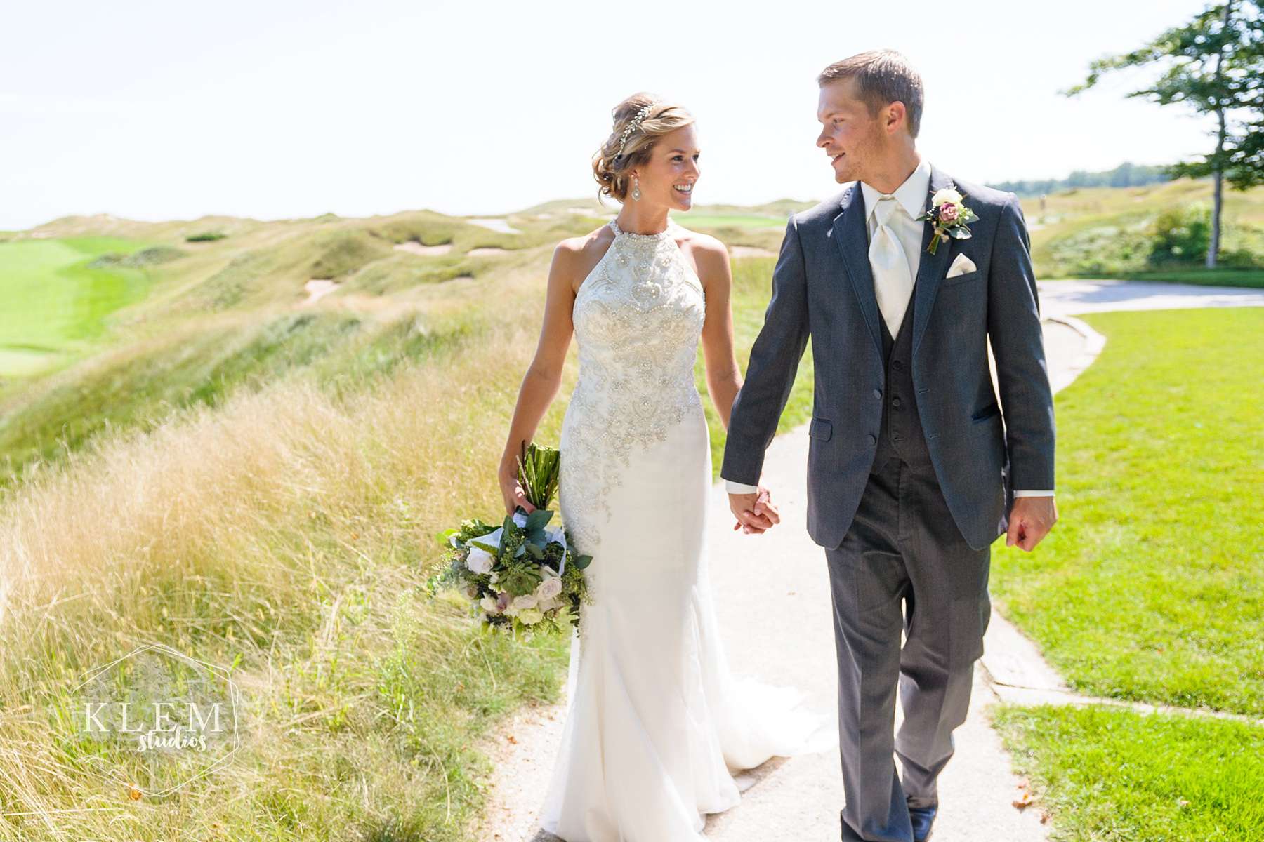 bride and groom walking hand in hand
