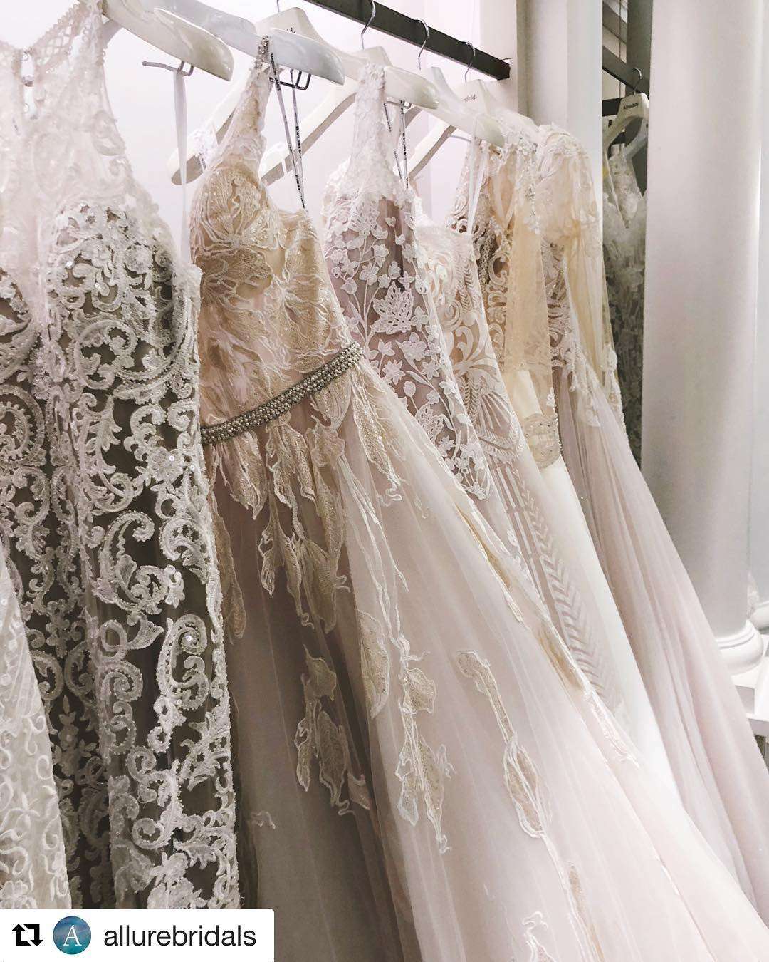 Elegant wedding gowns on rack.