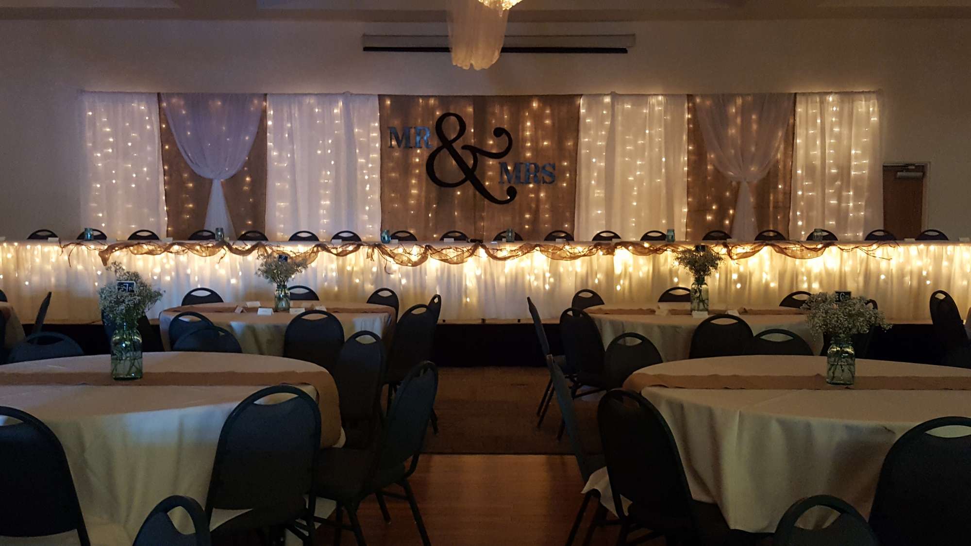 La Sure's Banquet Hall weddings- Head Table with draping and lighting