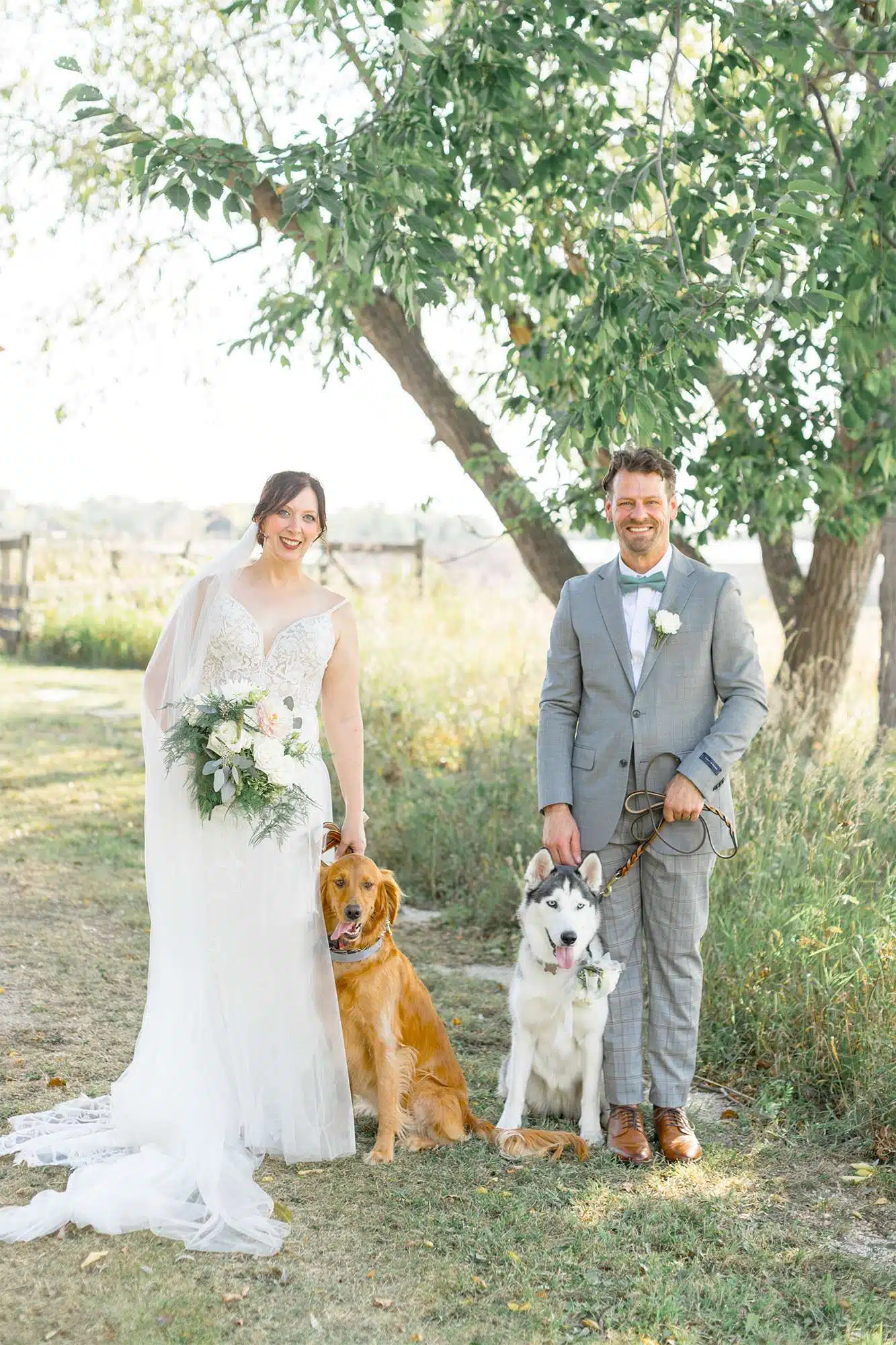 Bride and groom pose with dogs at Heritage Hill State Historical Park