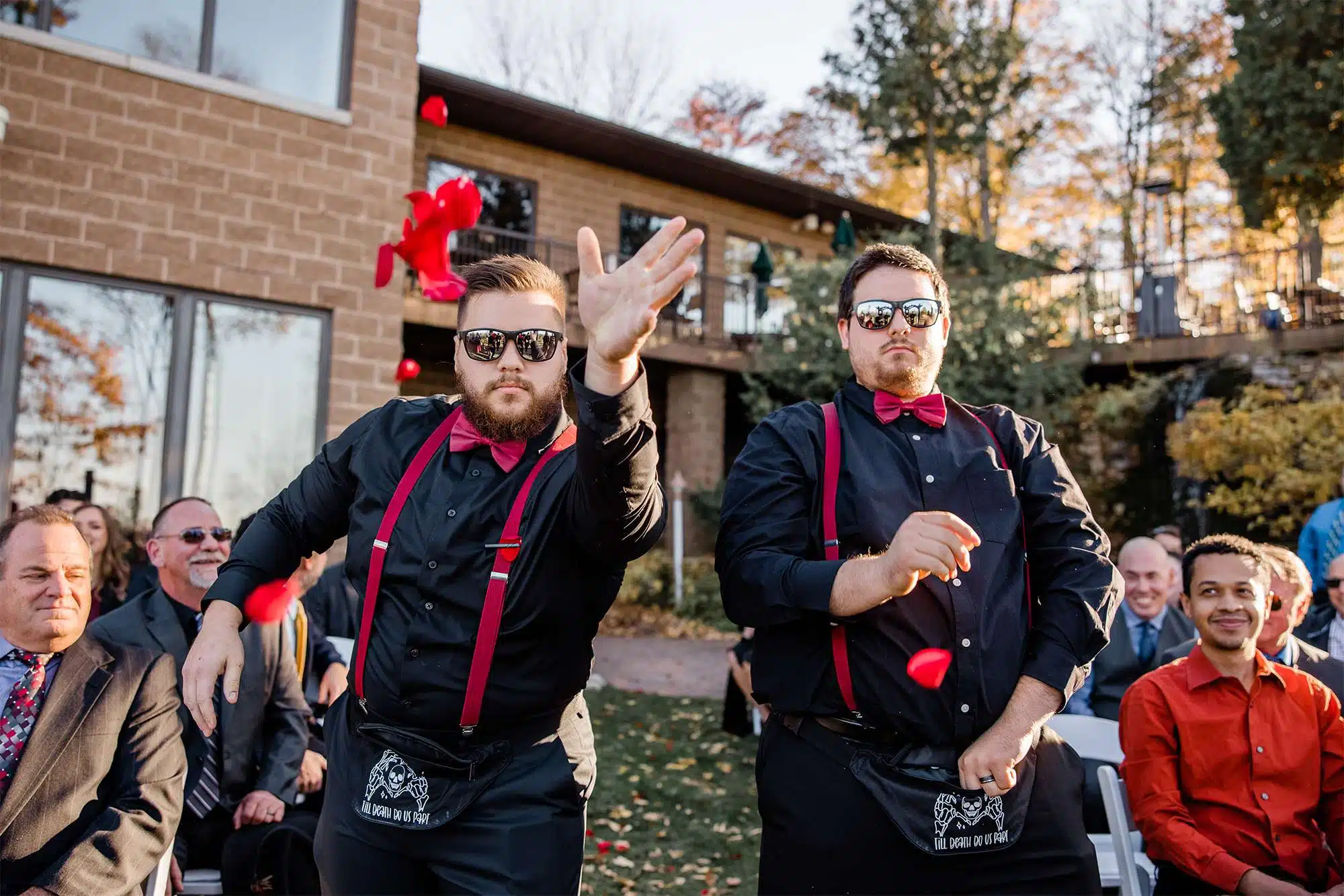 Flowers guys throw petals as they come down aisle.