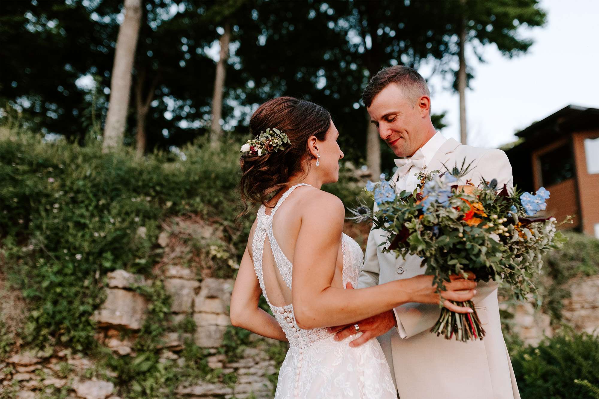 Groom looks at bride in her gown for the first time.