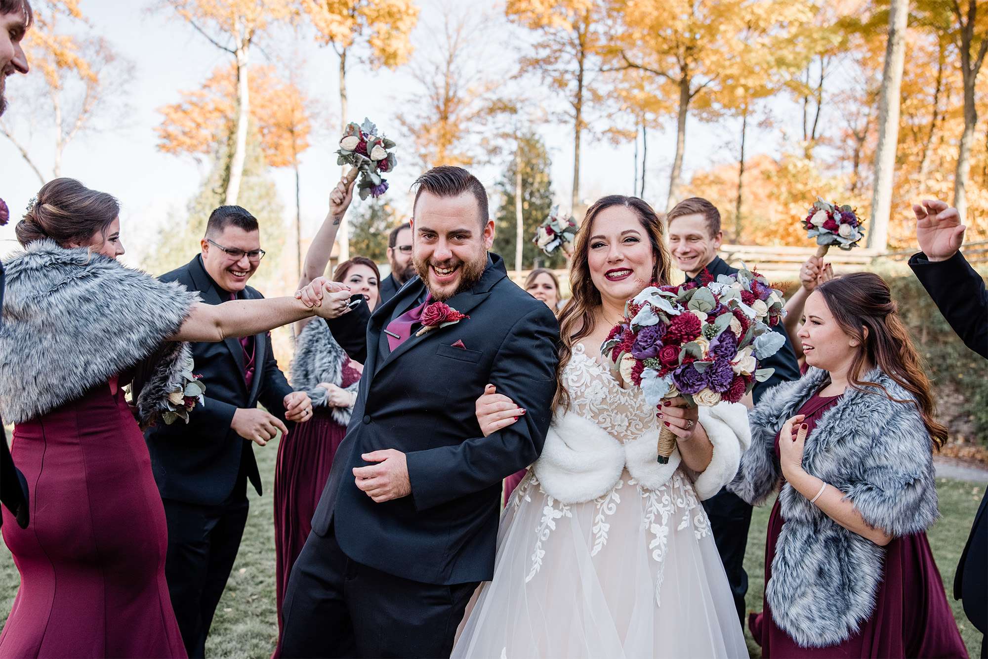 Bride and groom pose with wedding party.