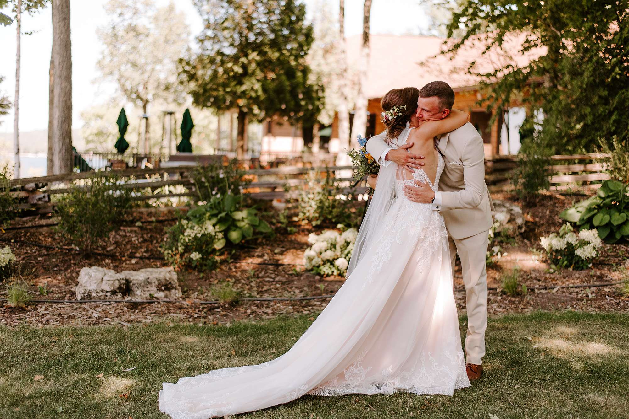 Bride and groom hug.