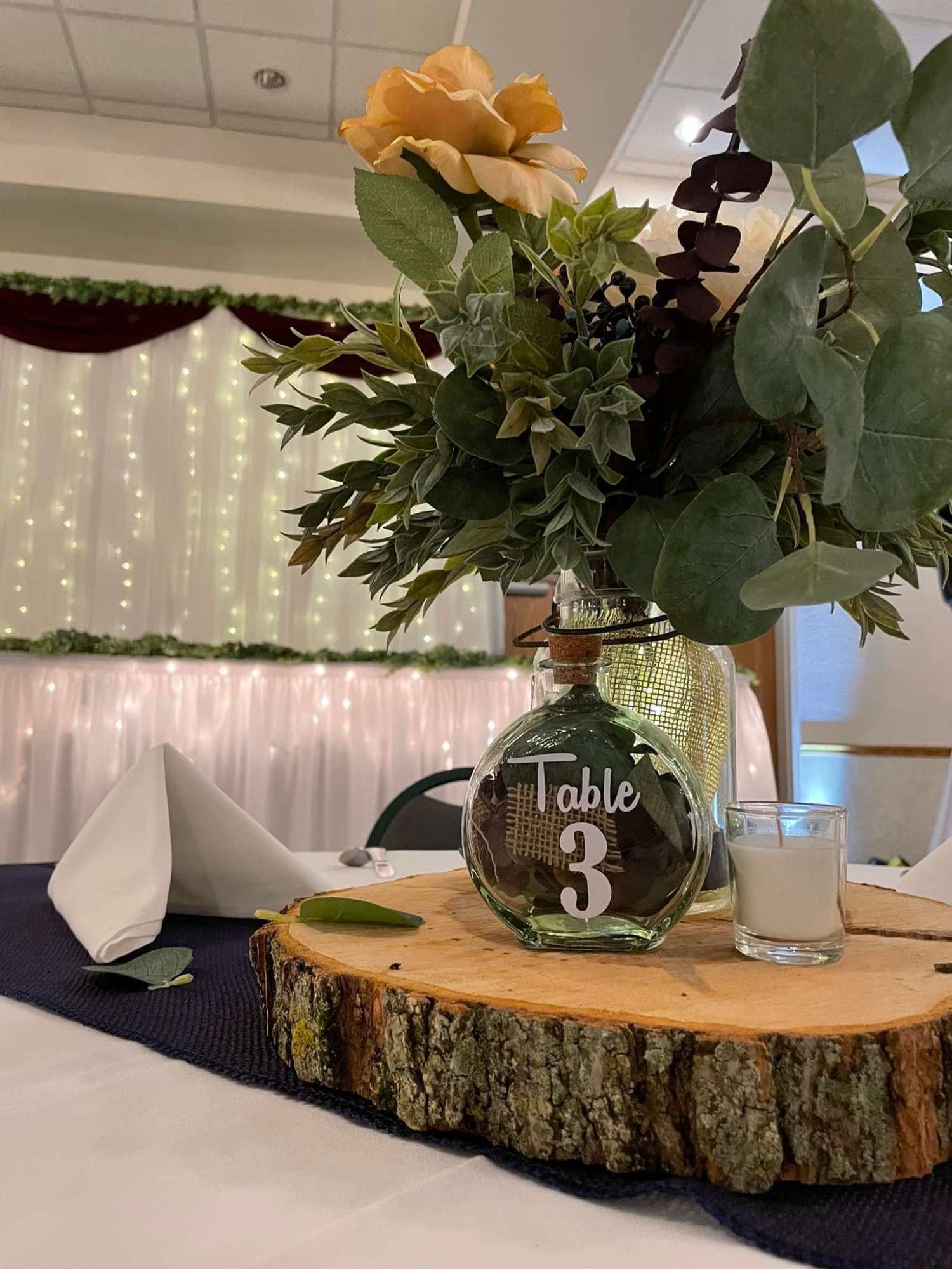 Head table with twinkle lights at LaSure's wedding reception in Oshkosh