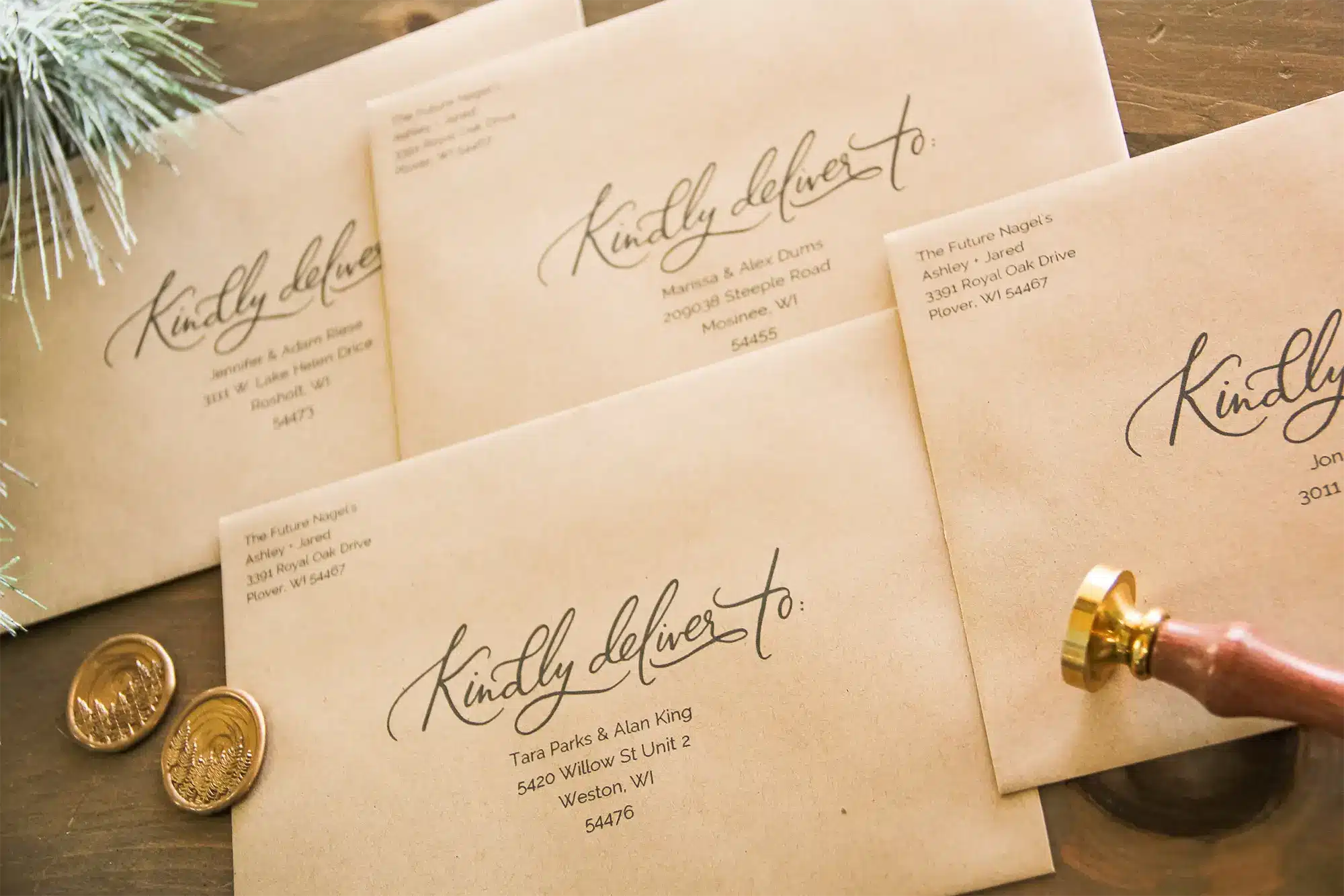 Custom envelopes with script writing and gold embossed seals
