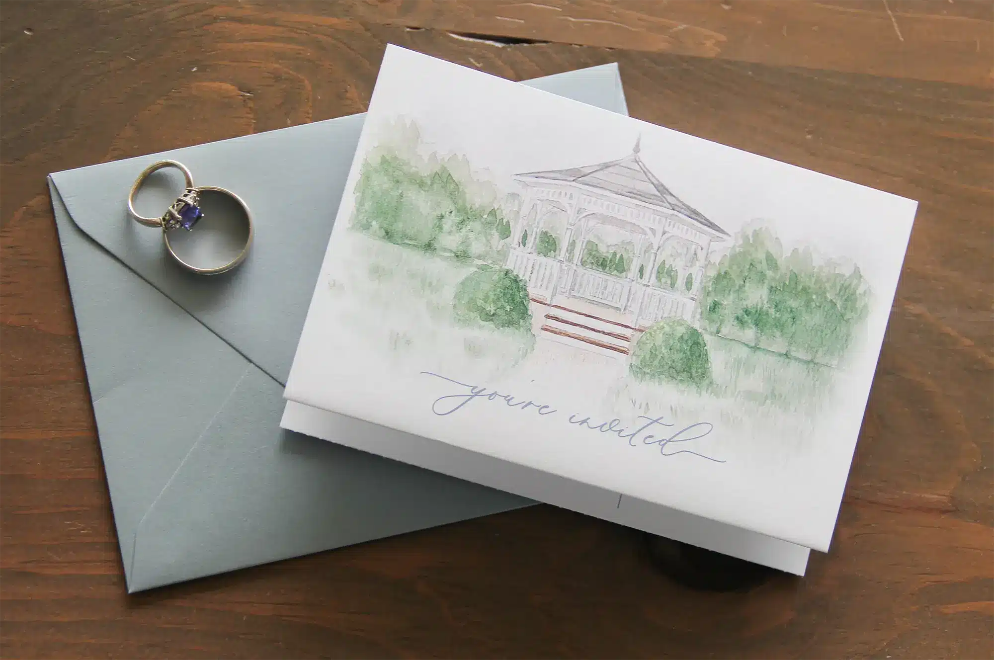 You're Invited card with watercolor gazebo and sage green envelope