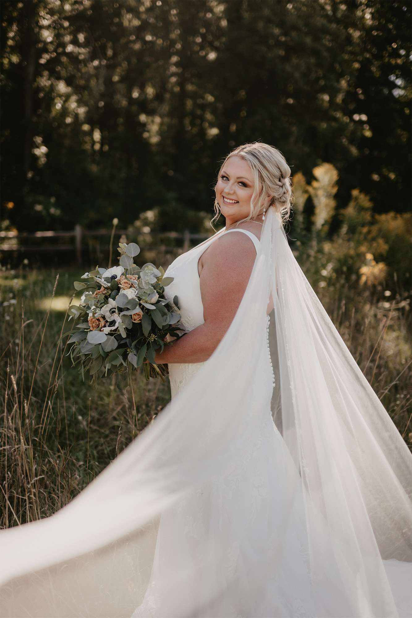 Beautiful bride poses with her boho chic bouquet