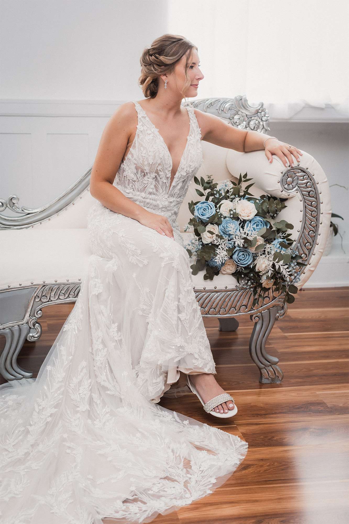 Bride with blue bouquet relaxing on couch