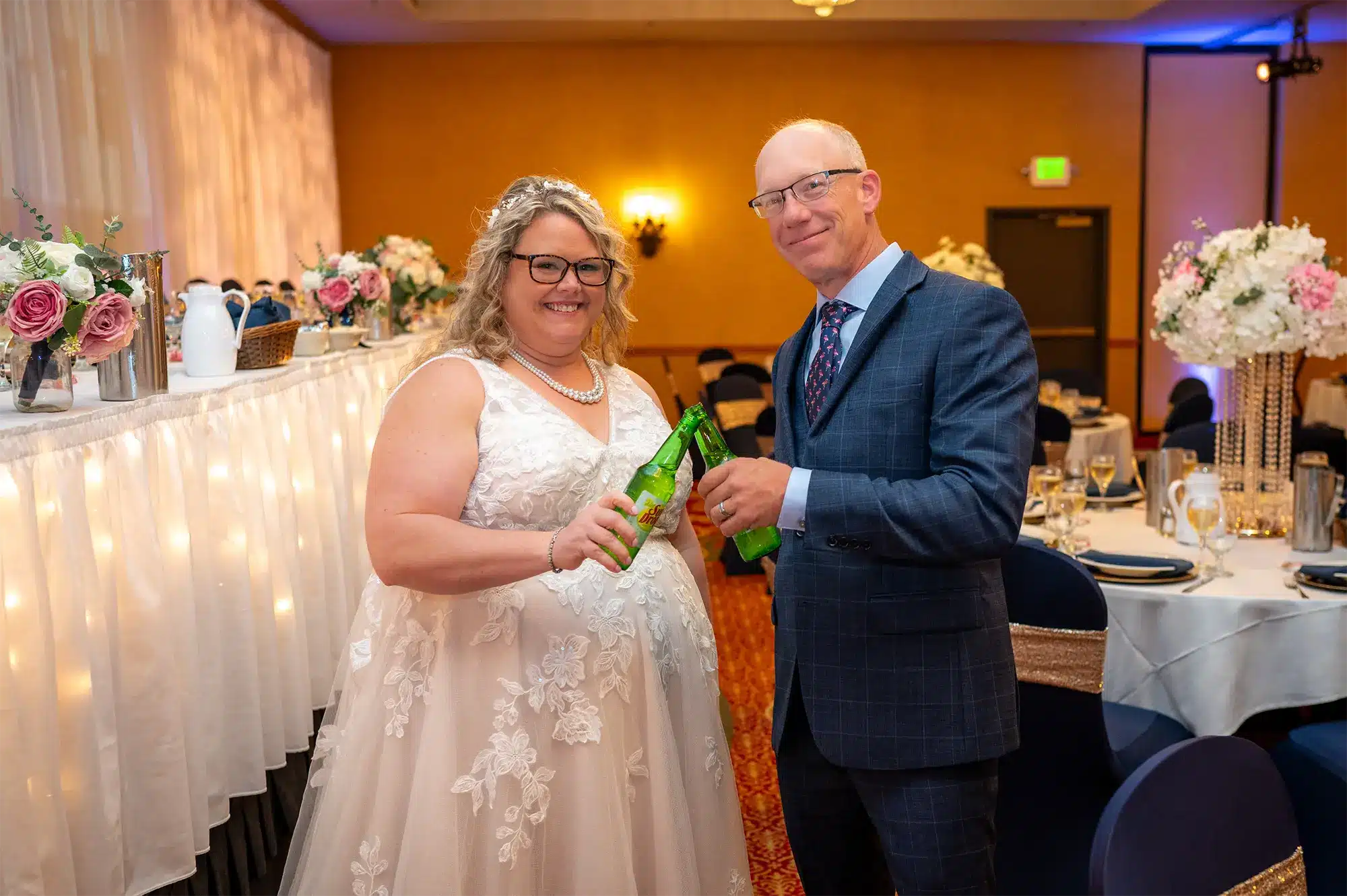 Bride and groom toasting with Sun Drop bottles during wedding reception at Tundra Lodge Resort & Conference Center.