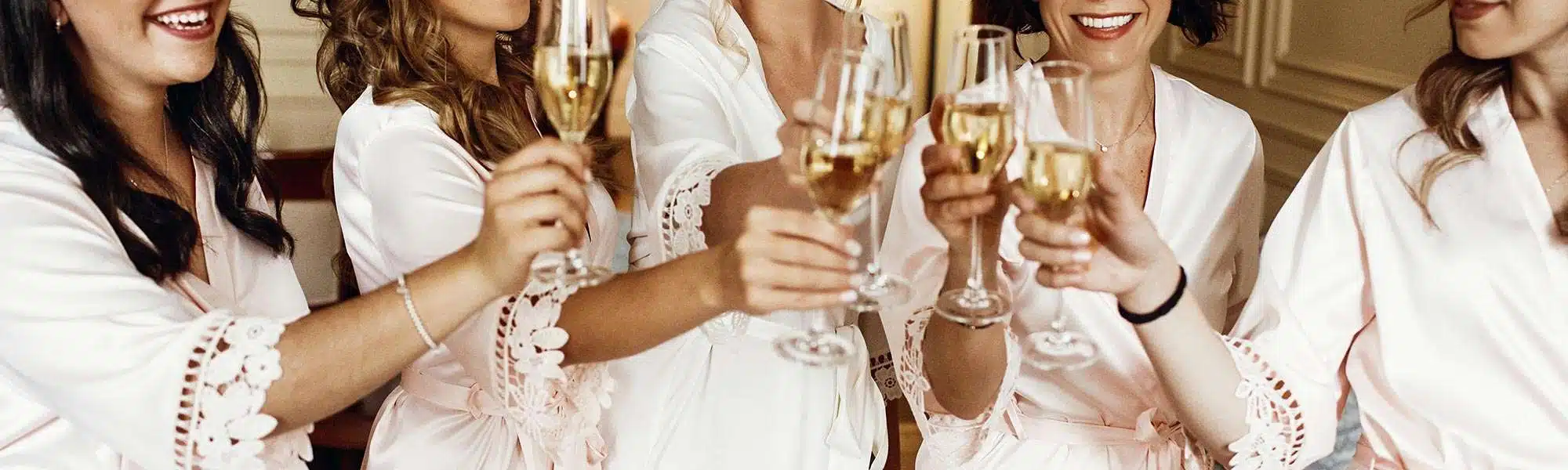 Bridesmaids in robes toasting champagne Trend Watch: 4 Ideas to Make Your Day Your Own!