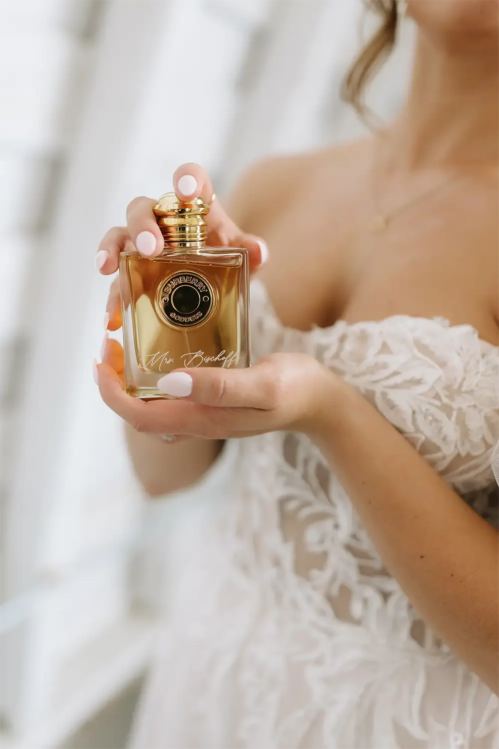 65-brianna-and-bradys-summer-wedding-in-chetek copy Bride holds her wedding day perfume.