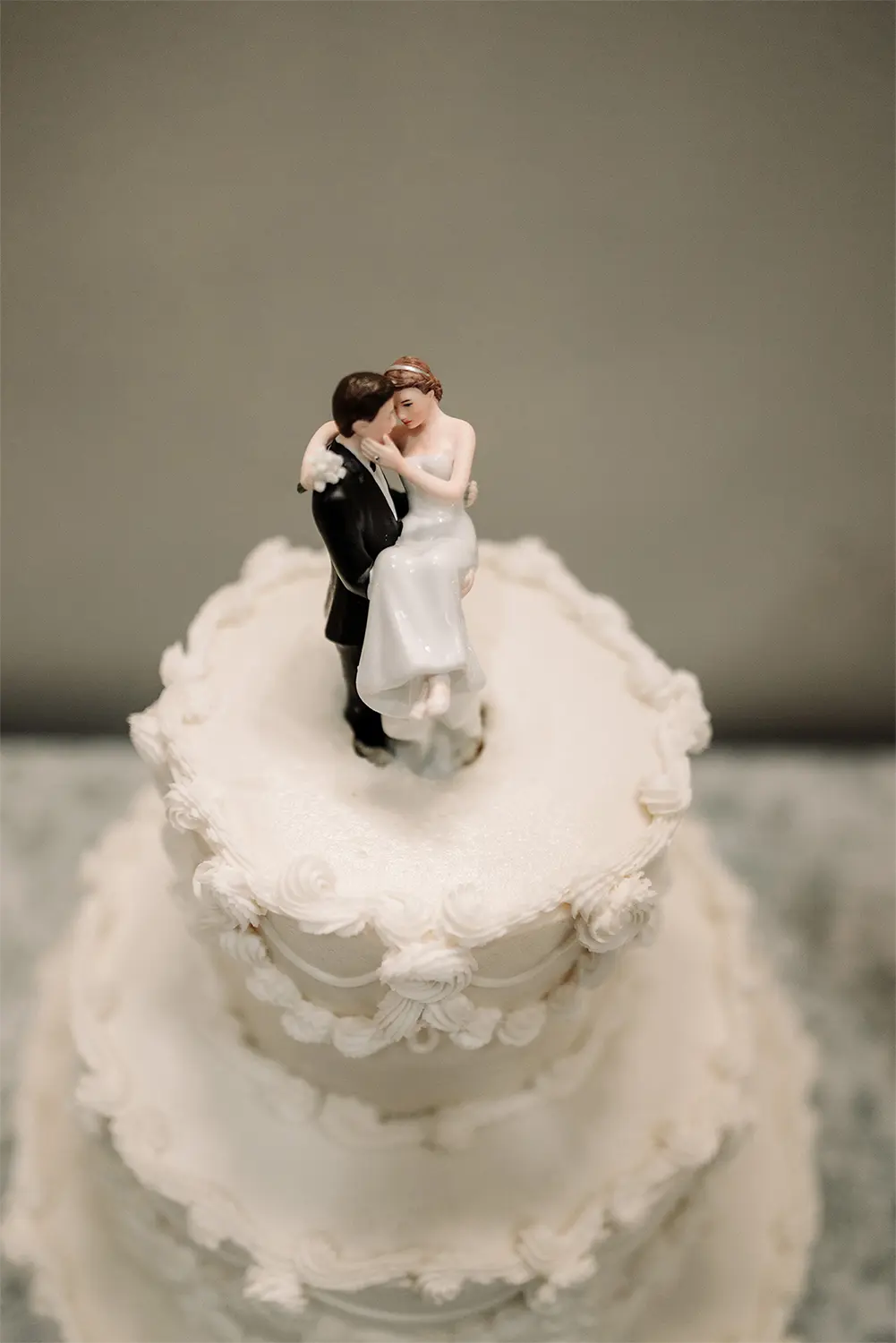 Elegant white wedding cake with Bride and Groom topper at Heidel House wedding. Elegant white wedding cake with Bride and Groom topper at Heidel House wedding.
