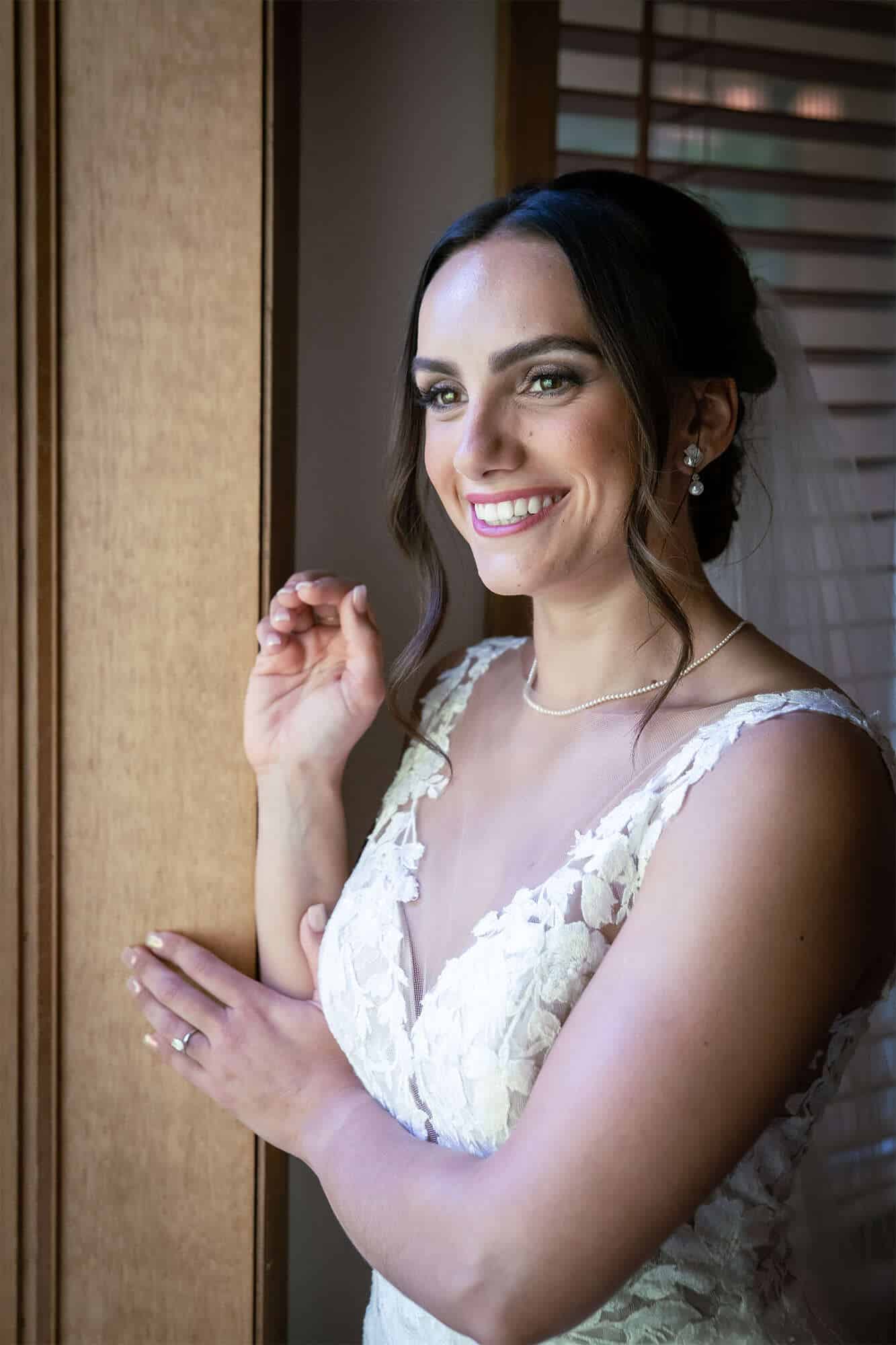 Beautiful bride gazes out window at the Landmark Resort