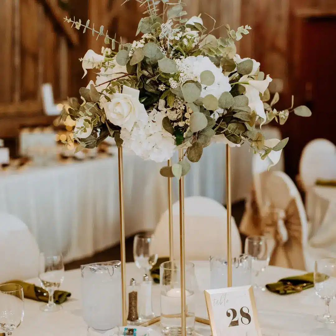 Floral centerpiece on tall gold metal stand by I Do Decorating & Rental Service