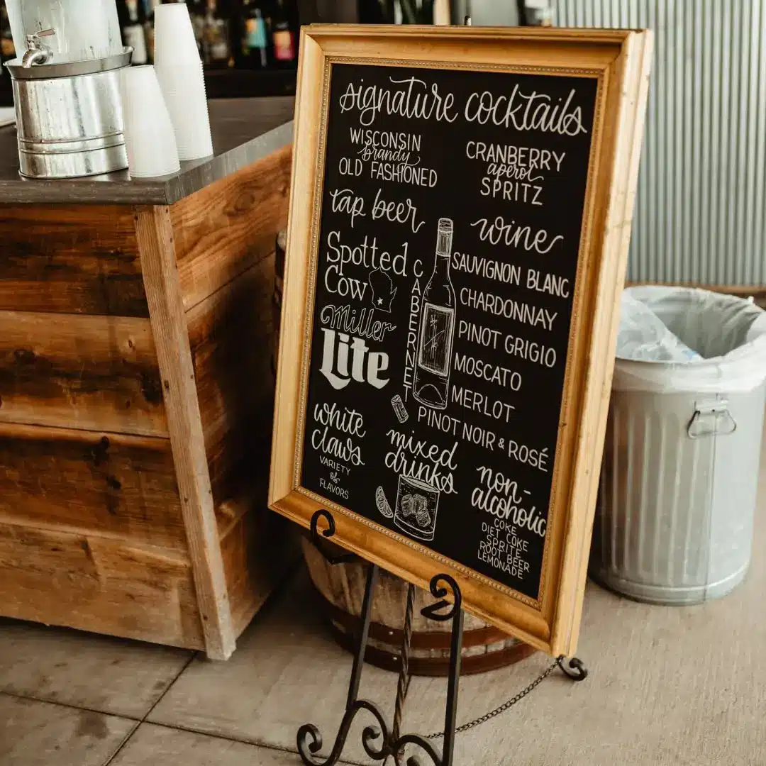 Signature cocktails custom signage with wood frame on easel by I Do Decorating & Rental Service