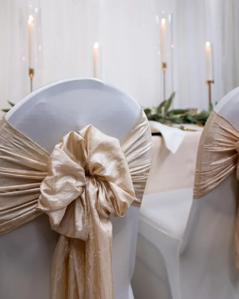 Elegant champagne colored chiffon chair bows by I Do Decorating & Rental Service