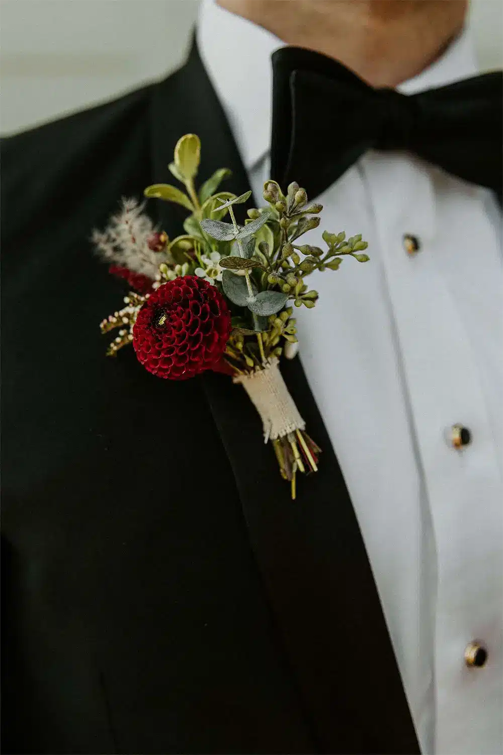 Classic and elegant groom style Boutonnière on black tuxedo.