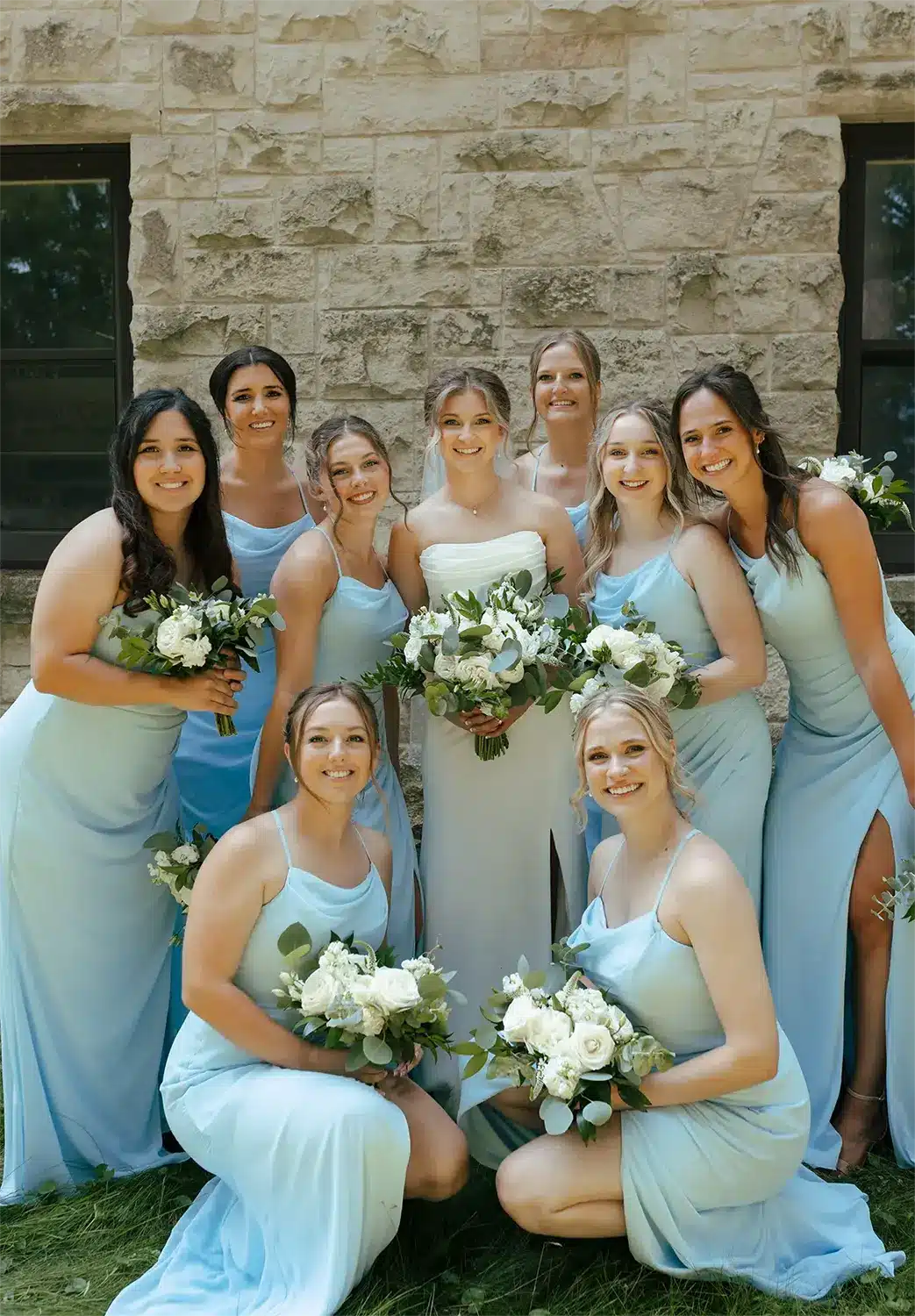 Bride with bridesmaids in pale blue gowns. Bride with bridesmaids in pale blue gowns.