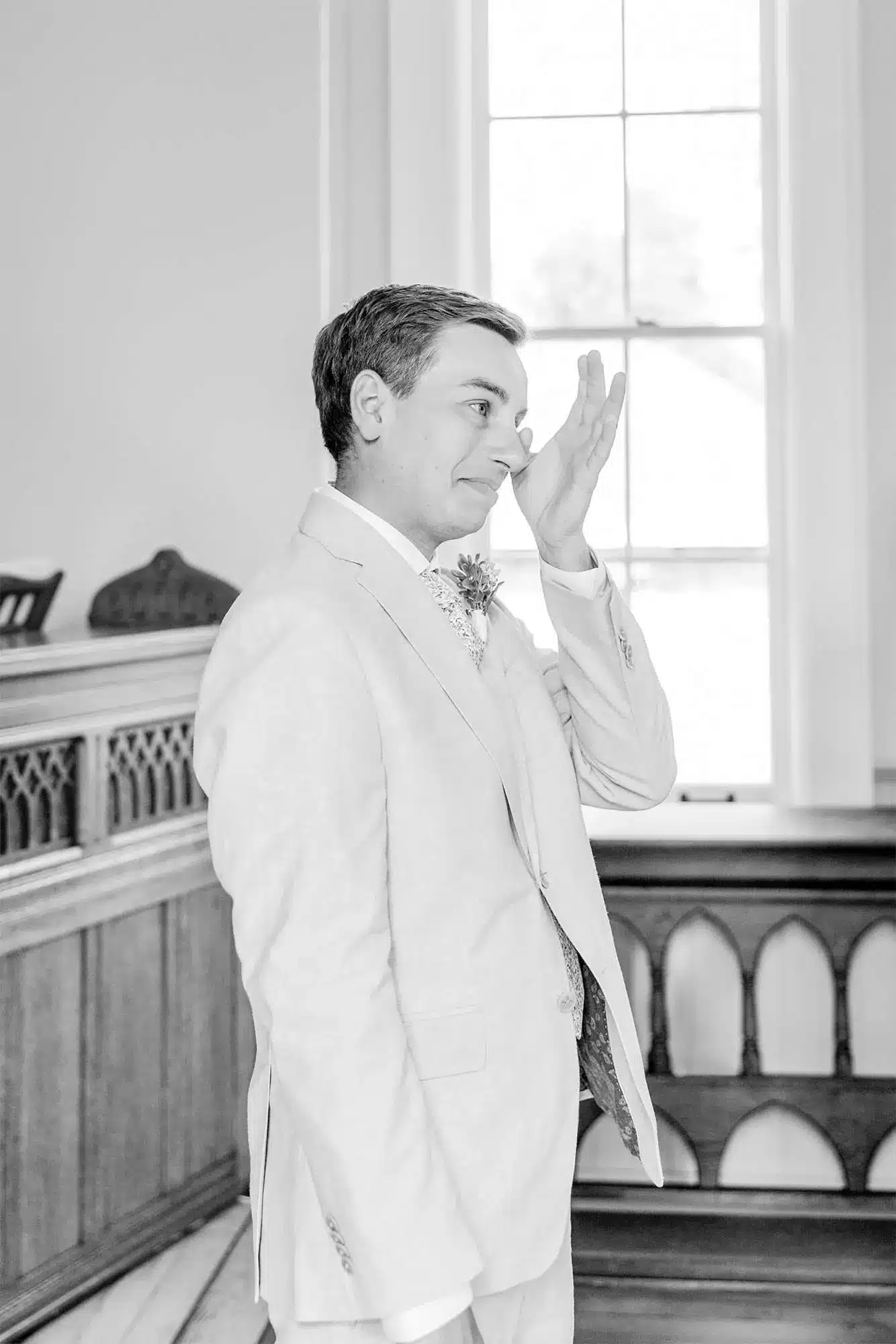 Clintonville-lakeside-wedding-reception-02 Groom wiping away tear as bride walks down aisle