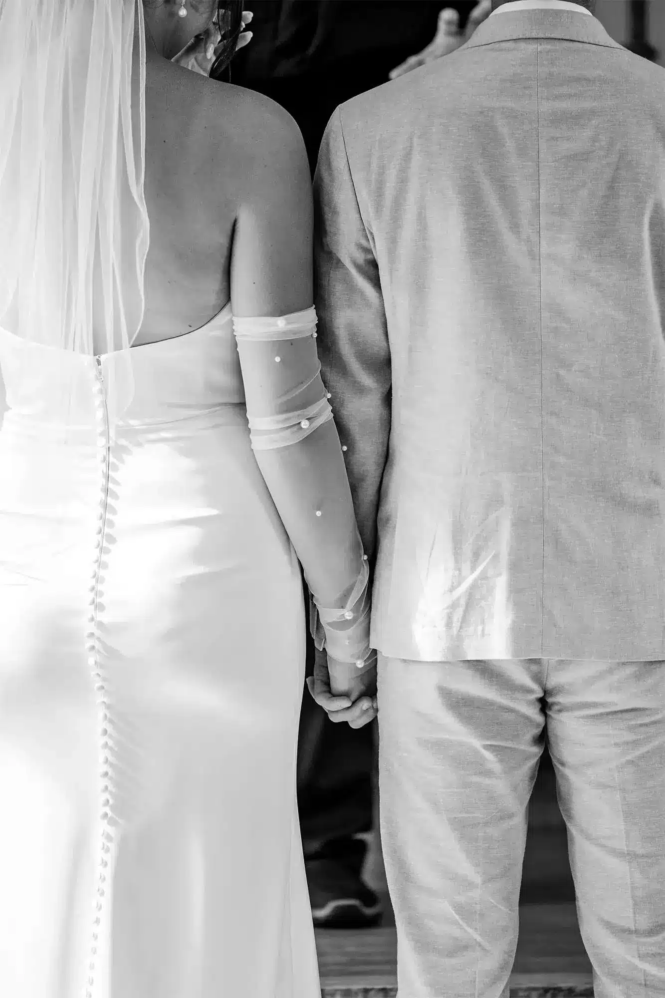 Back view of Bride and groom holding hands Back view of Bride and groom holding hands