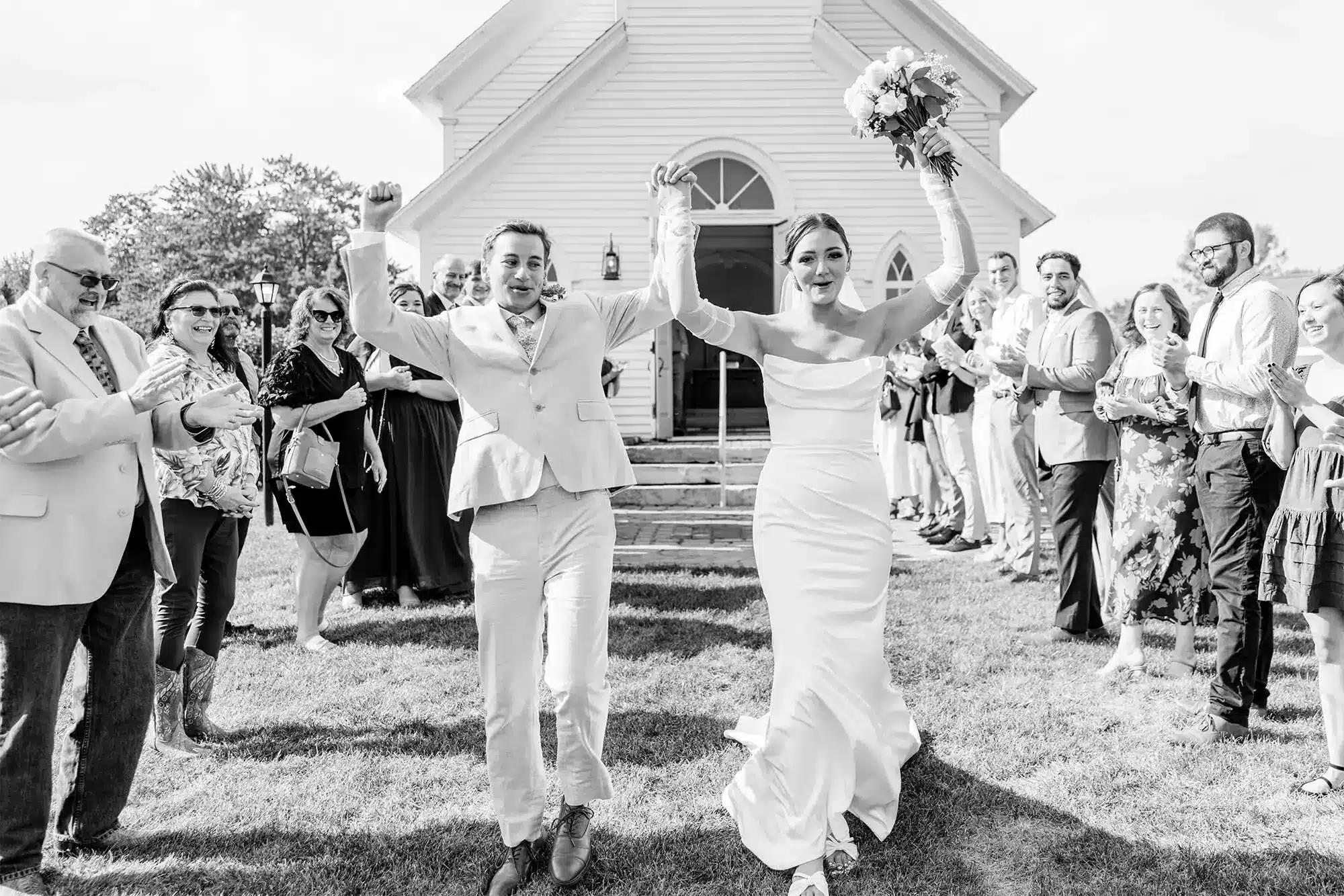 Clintonville-lakeside-wedding-reception-05 Bride and groom coming out of Old Tabor Church celebrating with guests lined up on both sides