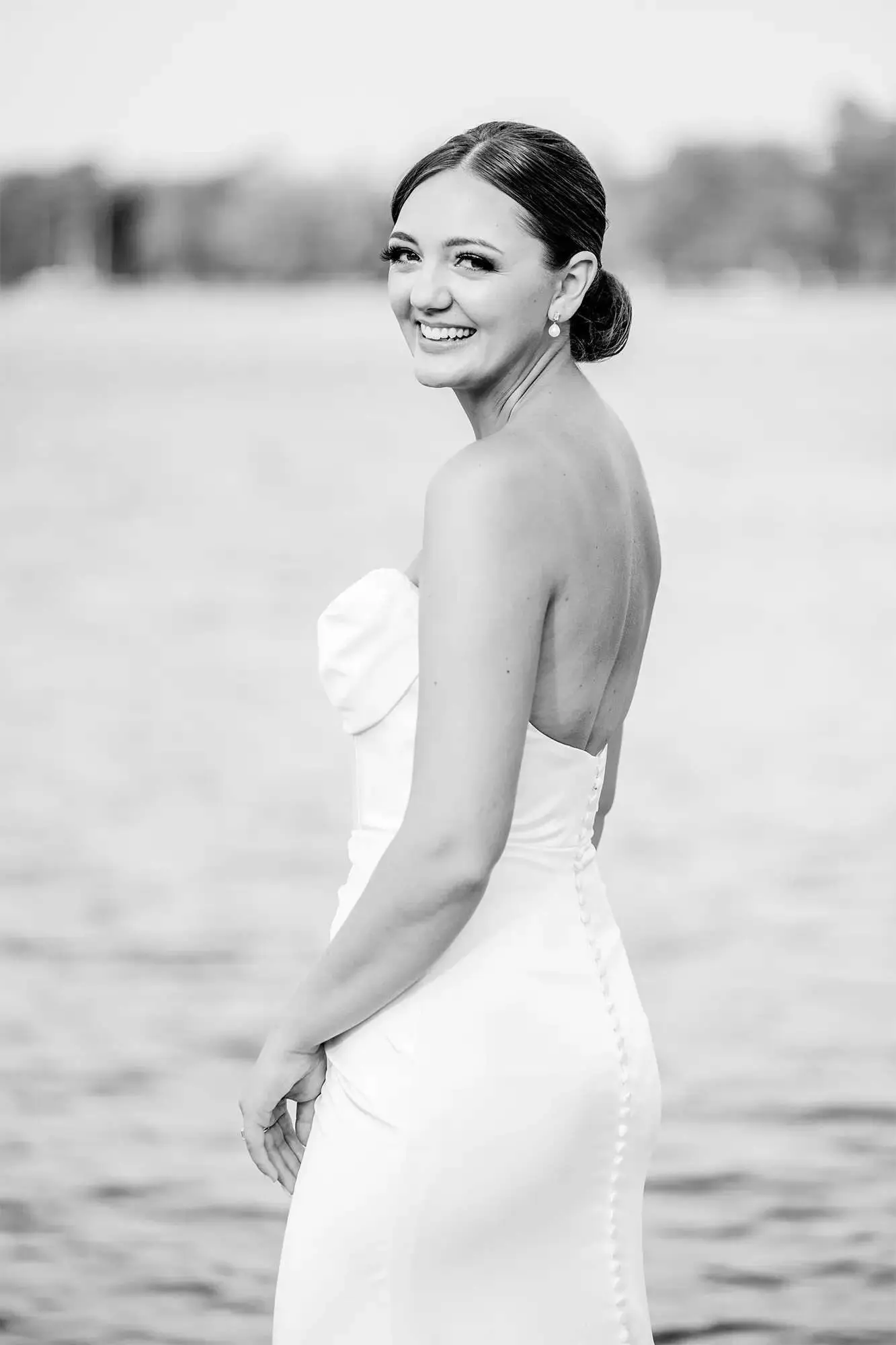 Clintonville-lakeside-wedding-reception-19 Bride's gown with covered button detail in back by Elaine's Wedding and Event Center