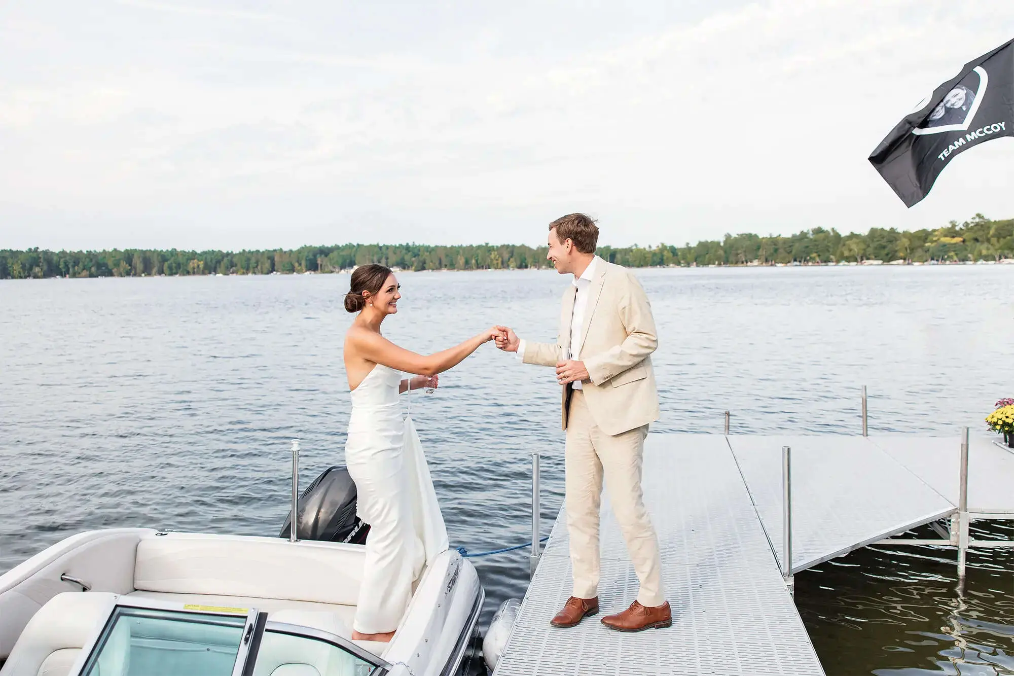 Clintonville-lakeside-wedding-reception-31 Groom helping bride out of boat