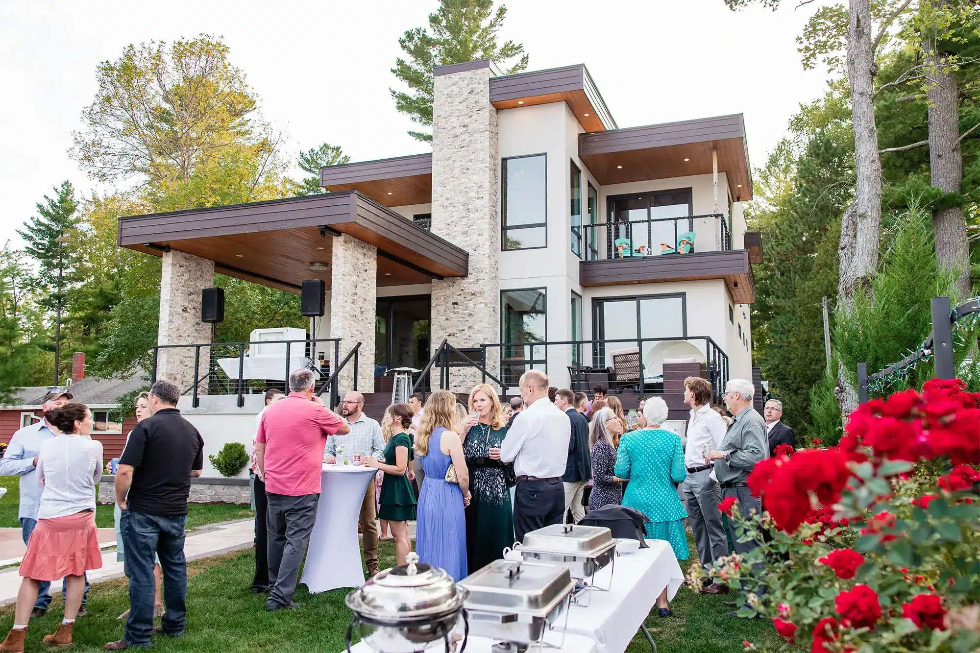 Clintonville-lakeside-wedding-reception-45 Guests visiting in front of bride's family home