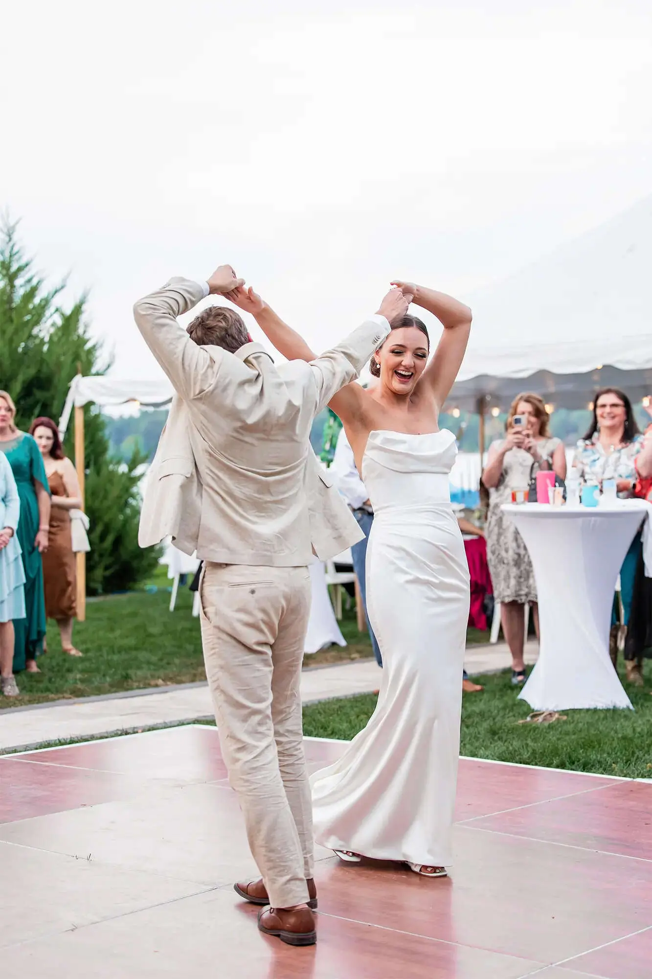Clintonville-lakeside-wedding-reception-49 Bride and groom showing off dance moves as guests look on