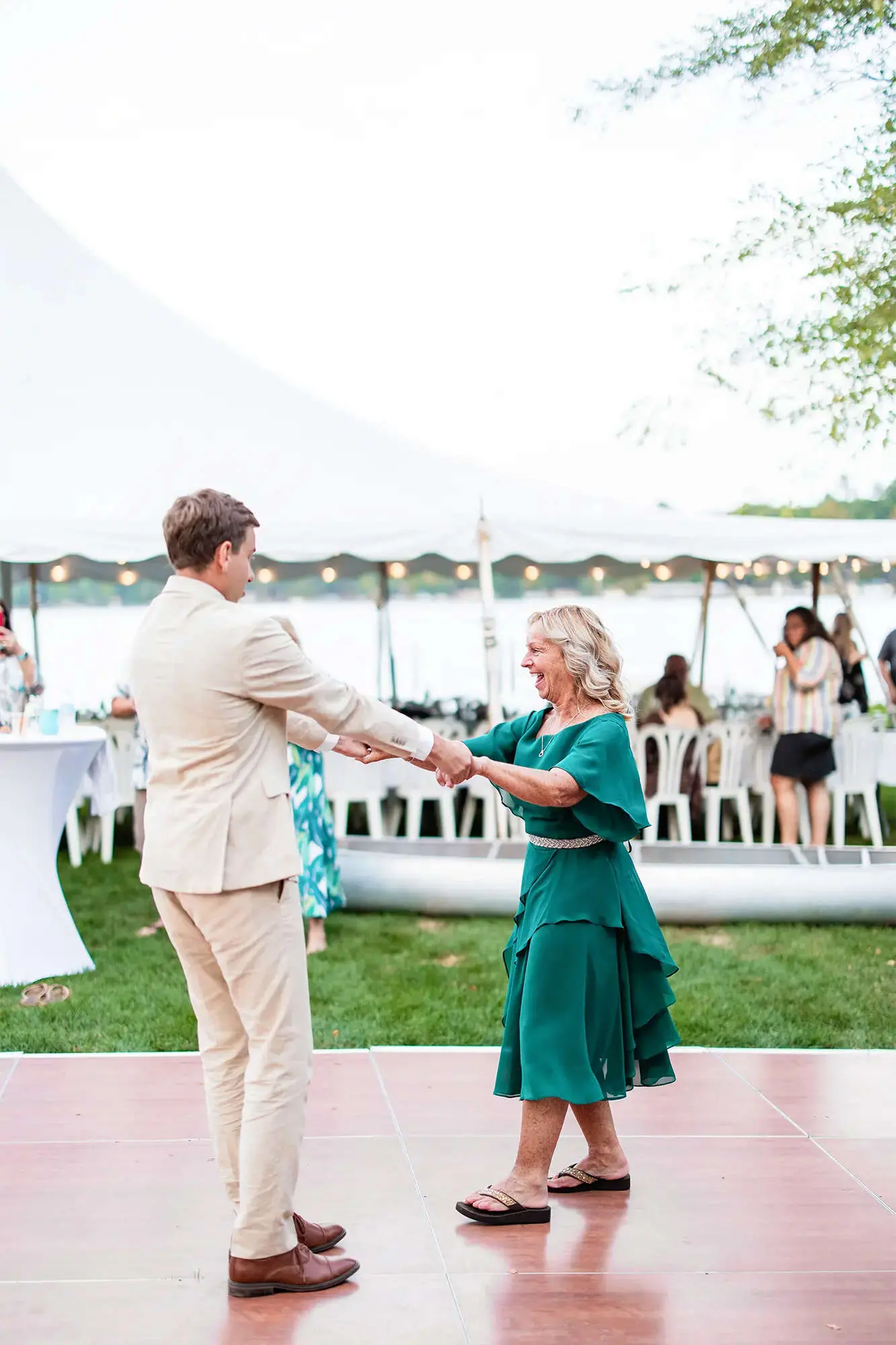 Clintonville-lakeside-wedding-reception-63 Groom sharing dance with mother in green tiered dress