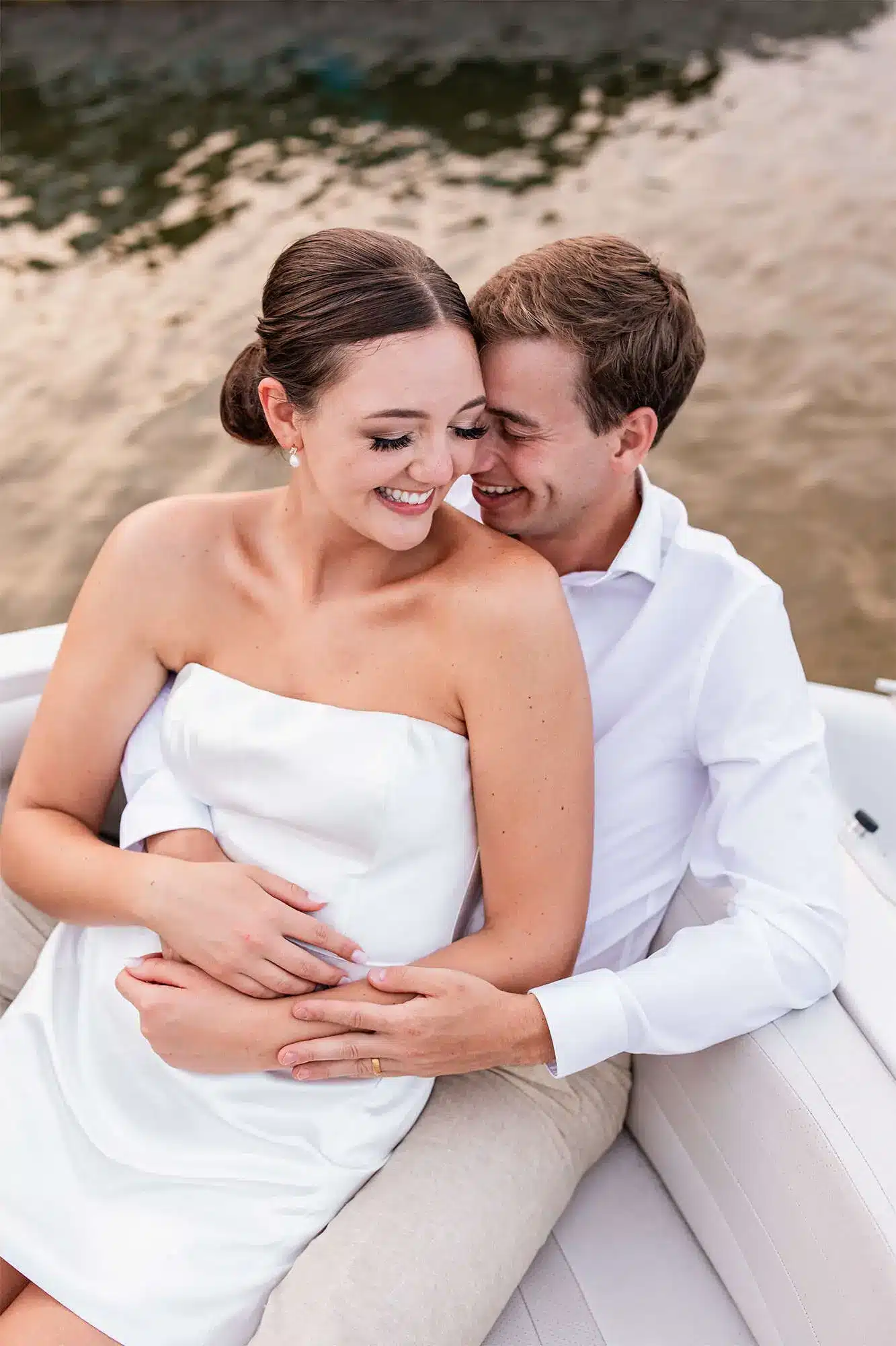 clintonville-lakeside-wedding-reception-74 Bride and groom share a tender moment as they sit in boat