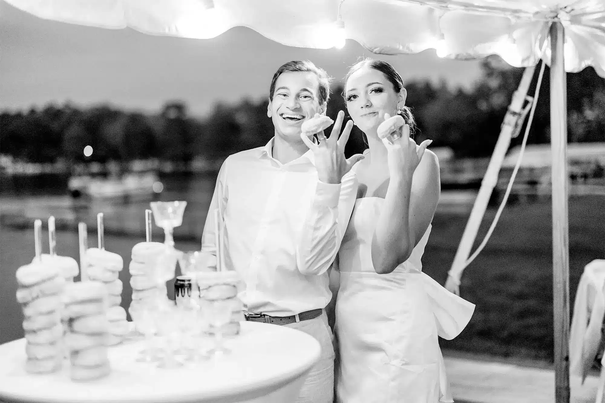 clintonville-lakeside-wedding-reception-81 bride and groom holding Kwik Trip glazer donuts on their fingers