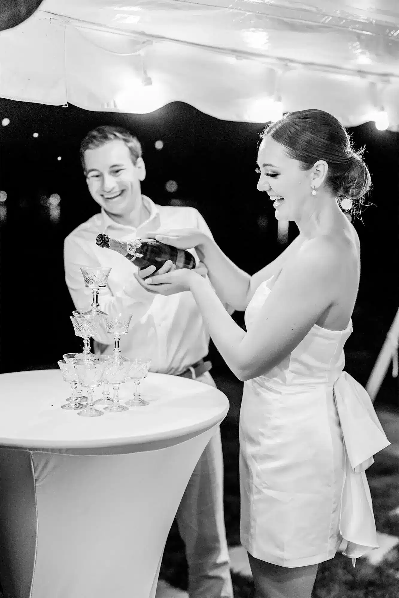 clintonville-lakeside-wedding-reception-85 Couple pouring champagne together into glass waterfall tower