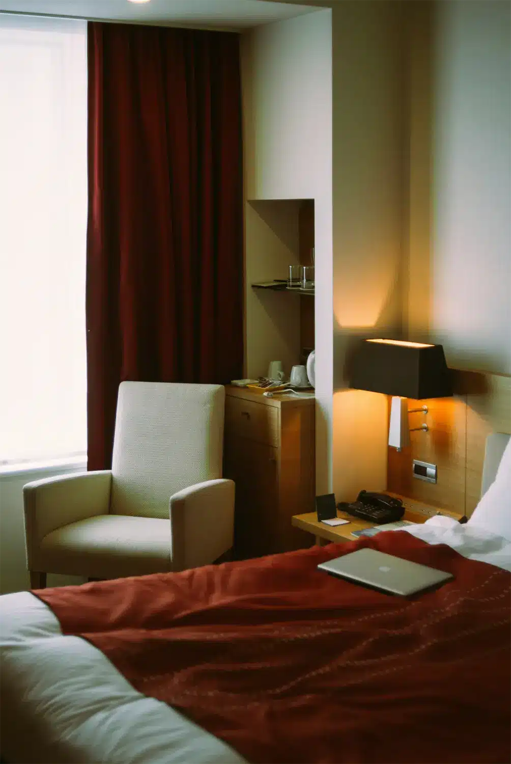 Hotel room with laptop on bed. hotel room with laptop on bed