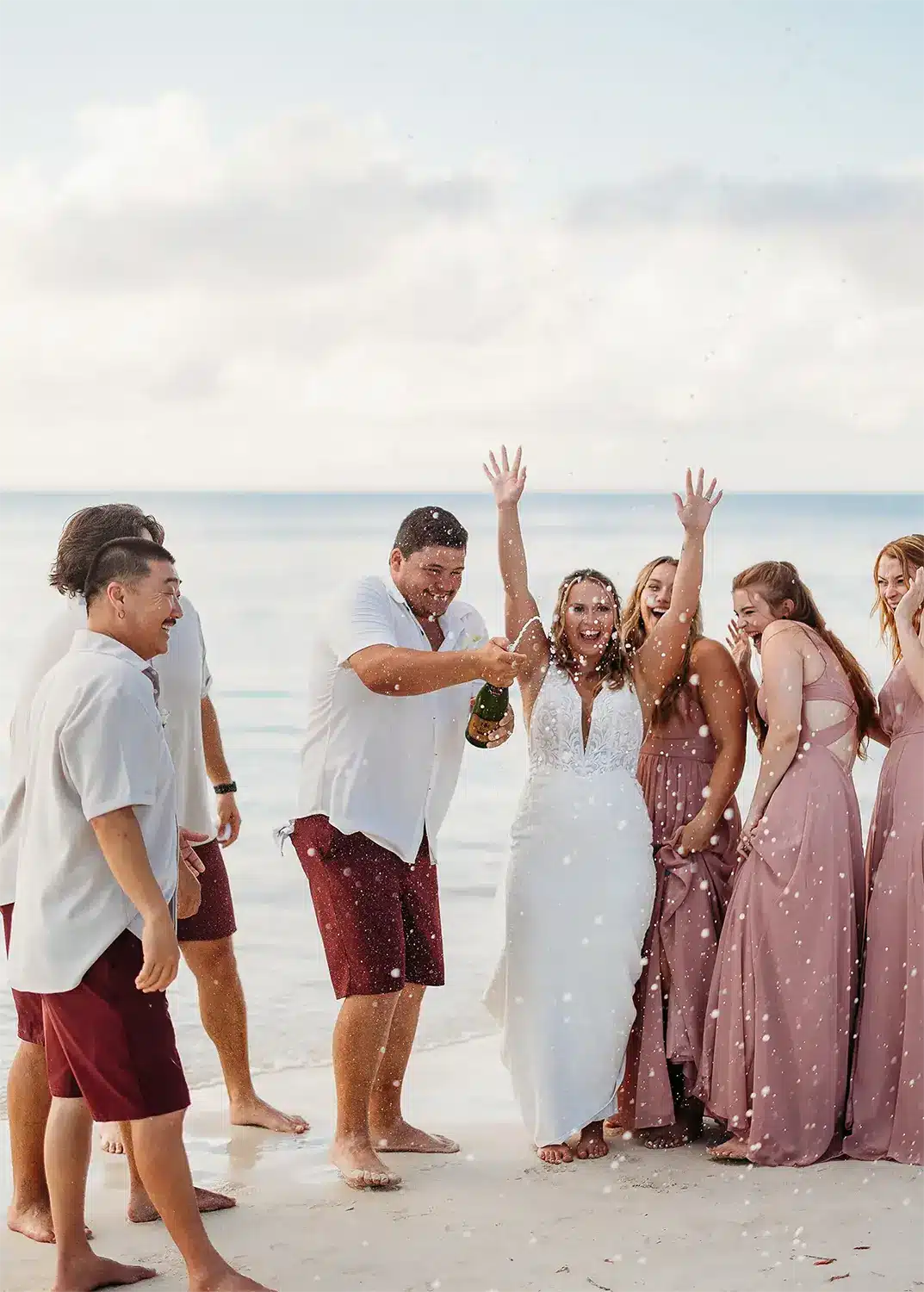 Couple celebrates tropical destination wedding on beach. Couple celebrates tropical destination wedding on beach.