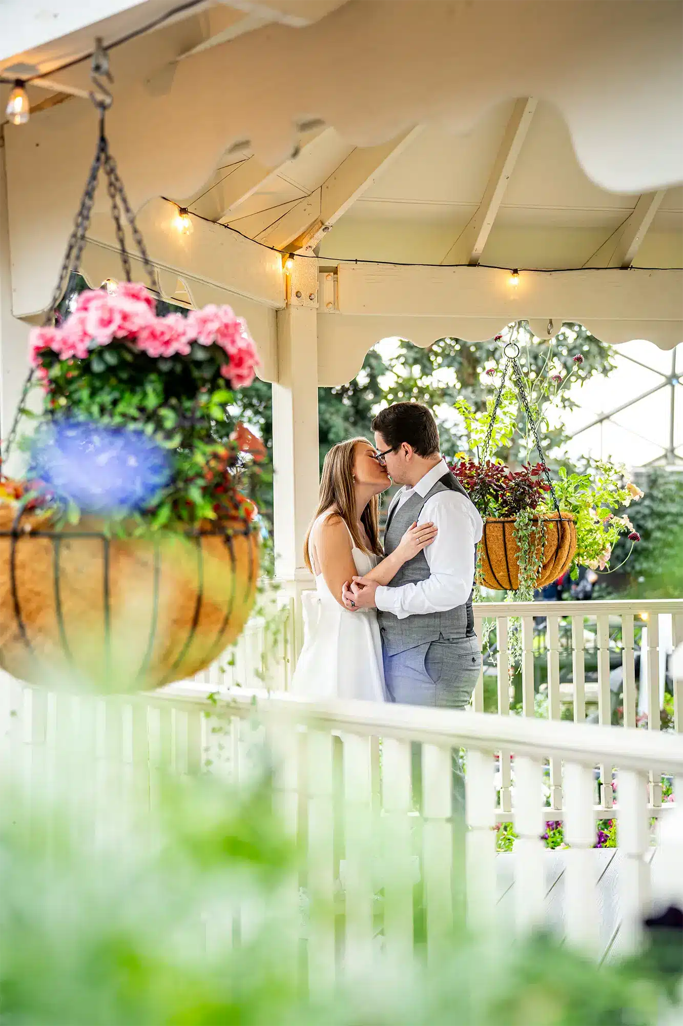 Bride and Groom share a kiss in lighted gazebo in Wisconsin. Bride and Groom share a kiss in lighted gazebo in Wisconsin.