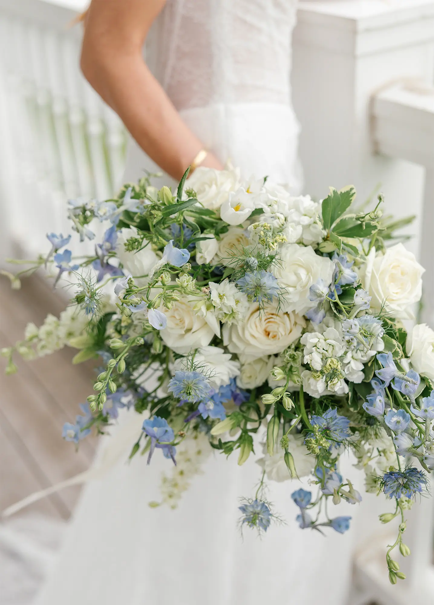 Romantic Garden Bouquet by The Stock Peddler Bridal bouquet with white roses and blue delphiniums from The Stock Peddler in Shawano, WI
