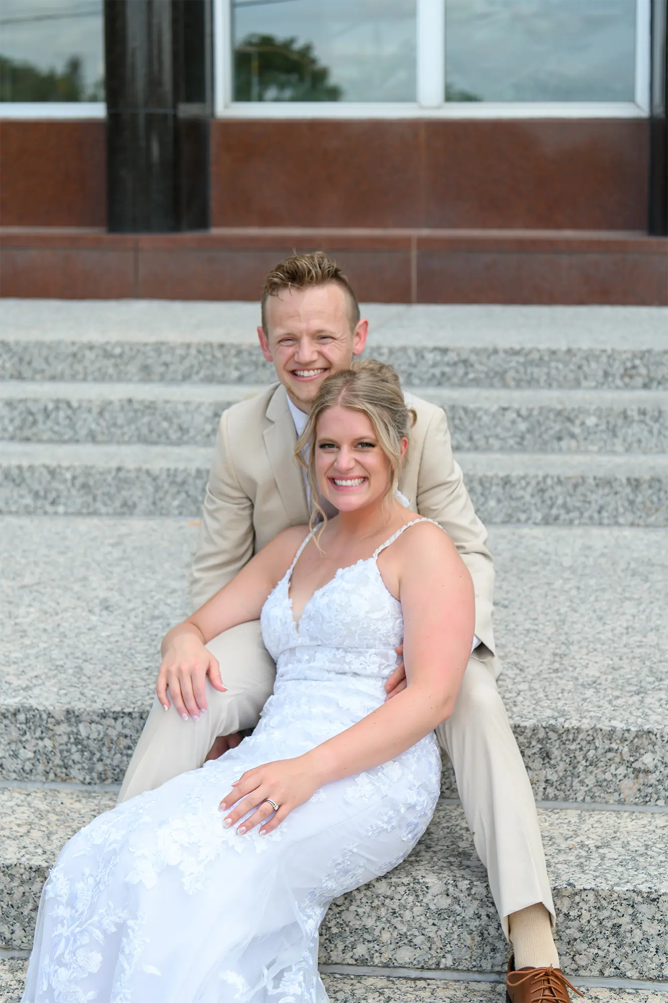 UW Stevens Point Summer Wedding Bride and groom pose on the steps of the Dreyfus Center.