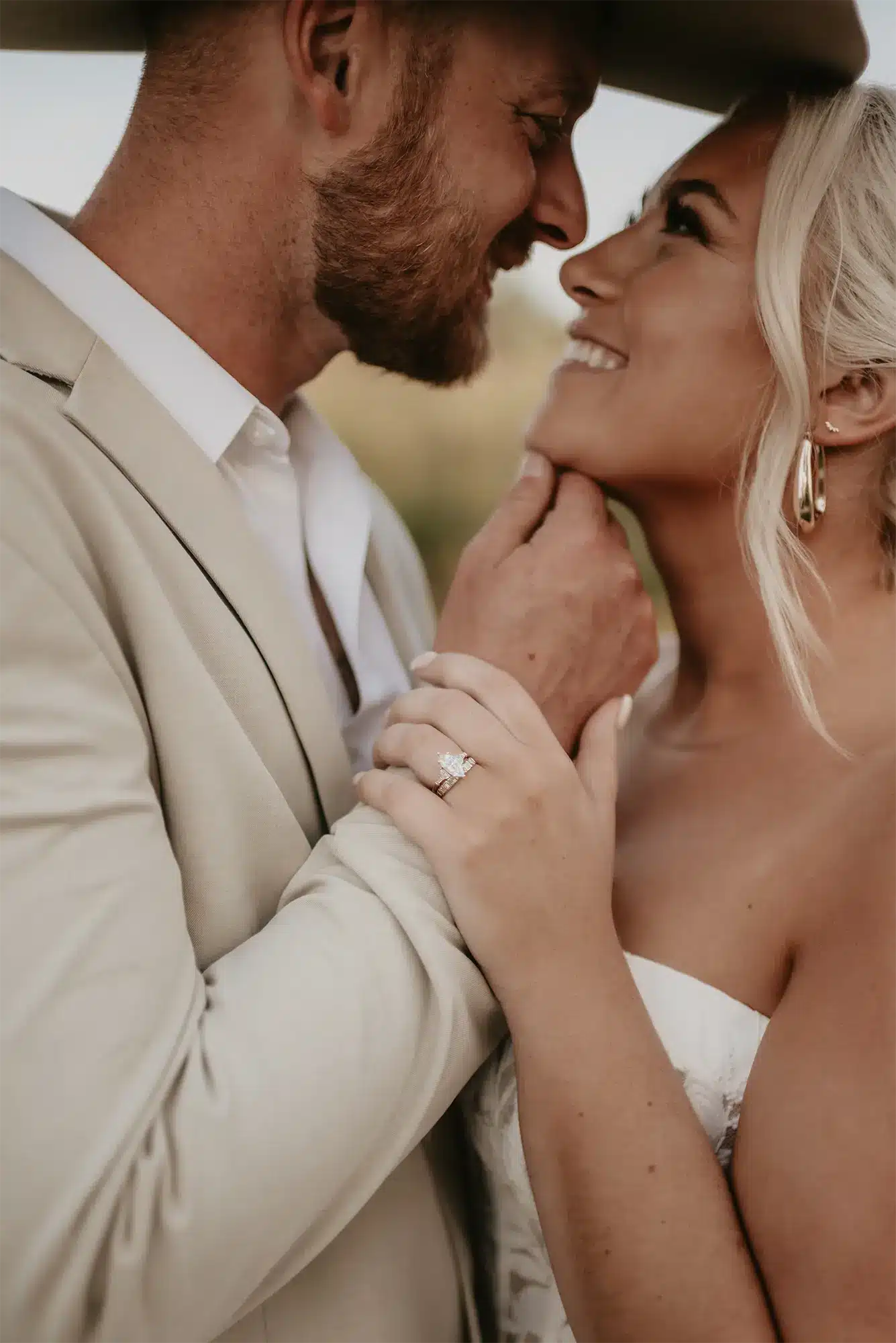 Intimate Couple Portrait with Engagement Ring Close-up of bride and groom smiling with engagement ring visible at Stone Prairie wedding
