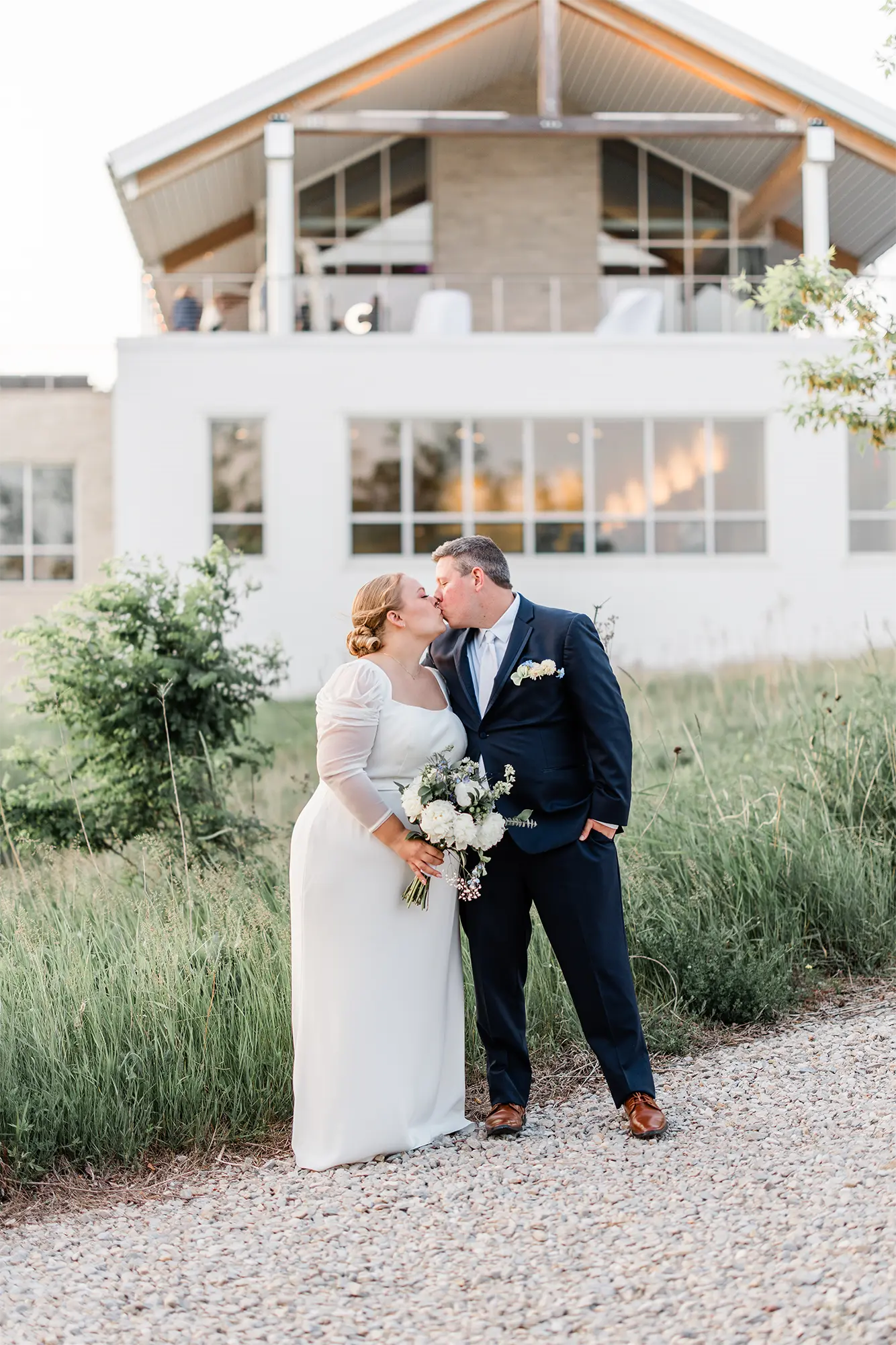 Romantic Outdoor Portrait at Kress Pavilion Bride and groom sharing a kiss outside Kress Pavilion during their June wedding in Door County, Wisconsin.