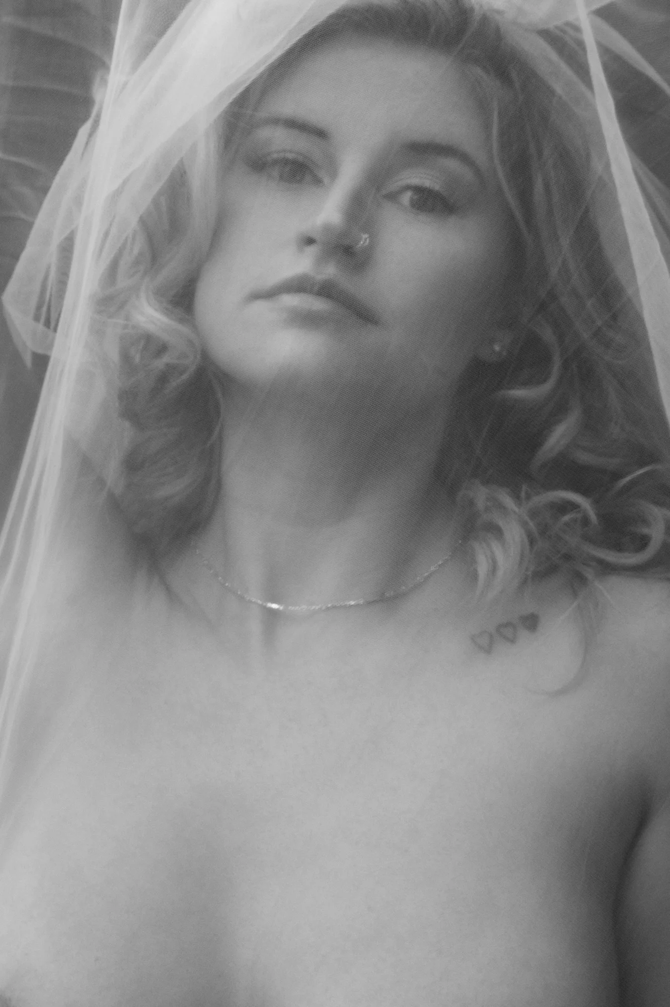 Soft-focus black-and-white portrait of a woman with natural styling.