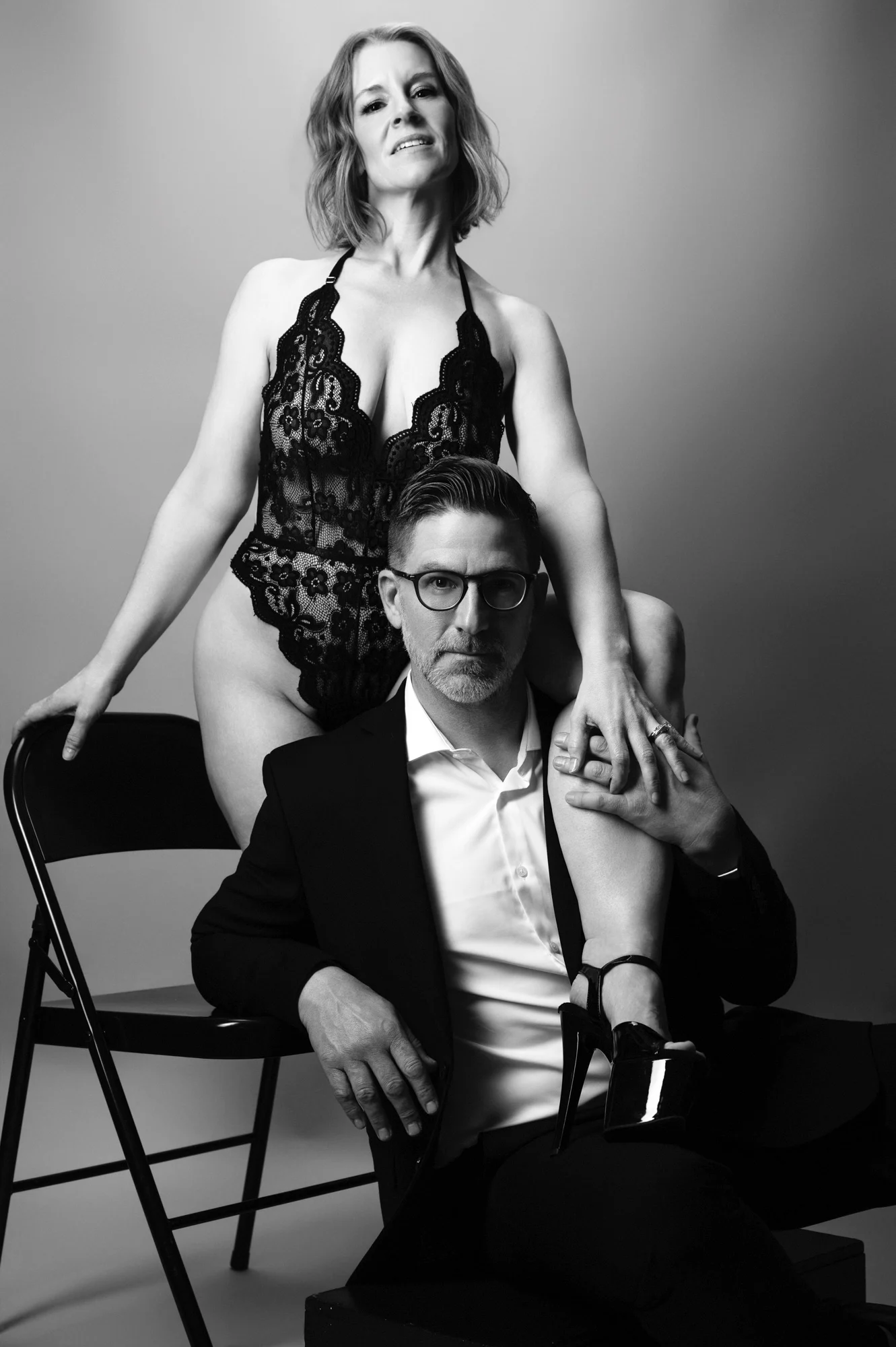Couple posing together in an artistic black-and-white portrait session.